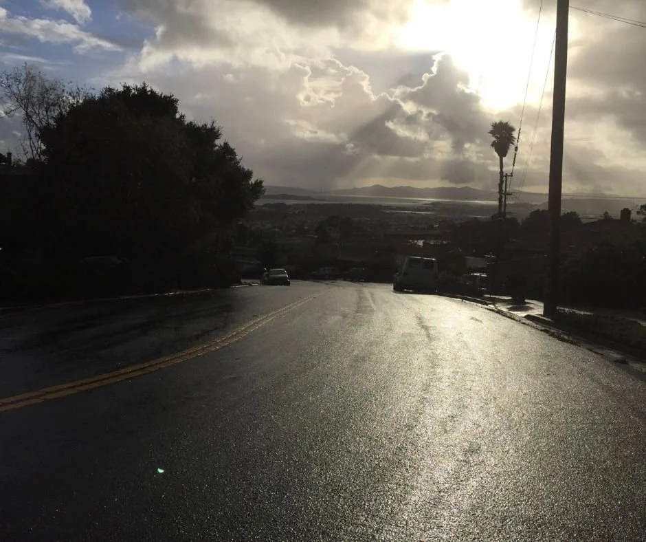 El Cerrito CA sunset reflection on wet road.
