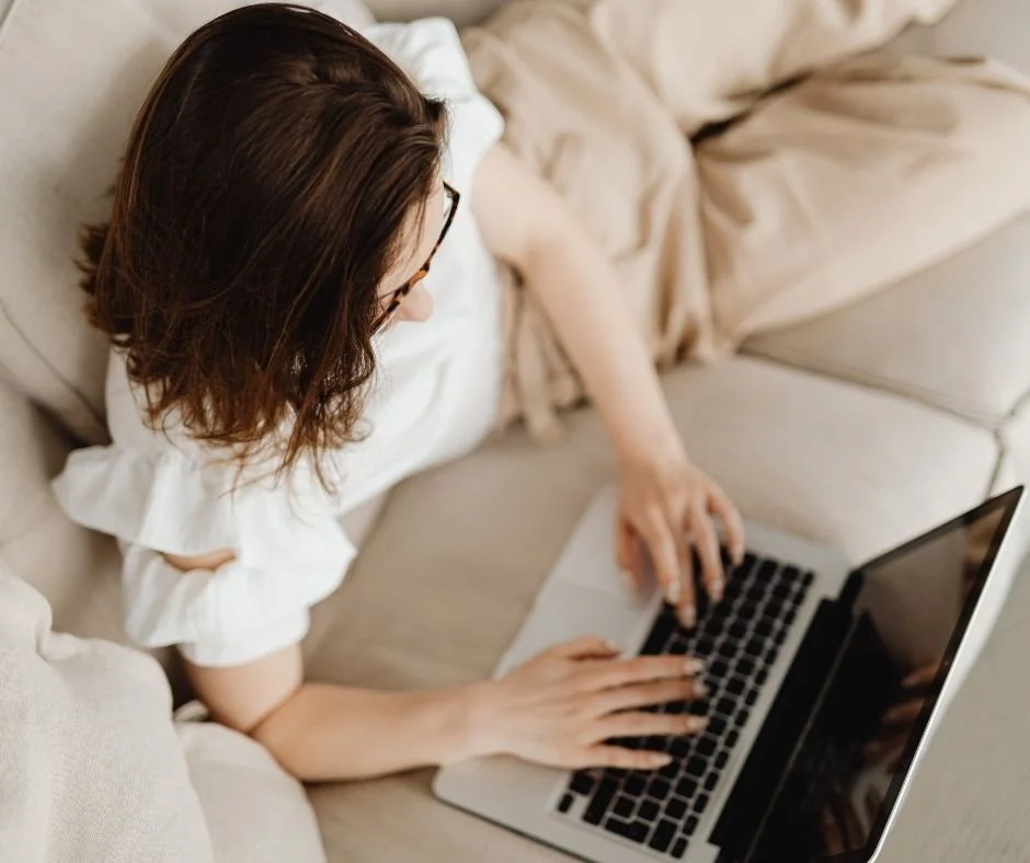 Woman using a laptop from home, representing convenient online therapy options for clients across California.