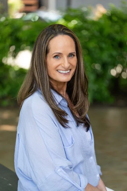 Anita, compassionate therapist at Bountiful Health, smiling in a professional portrait against a neutral background.