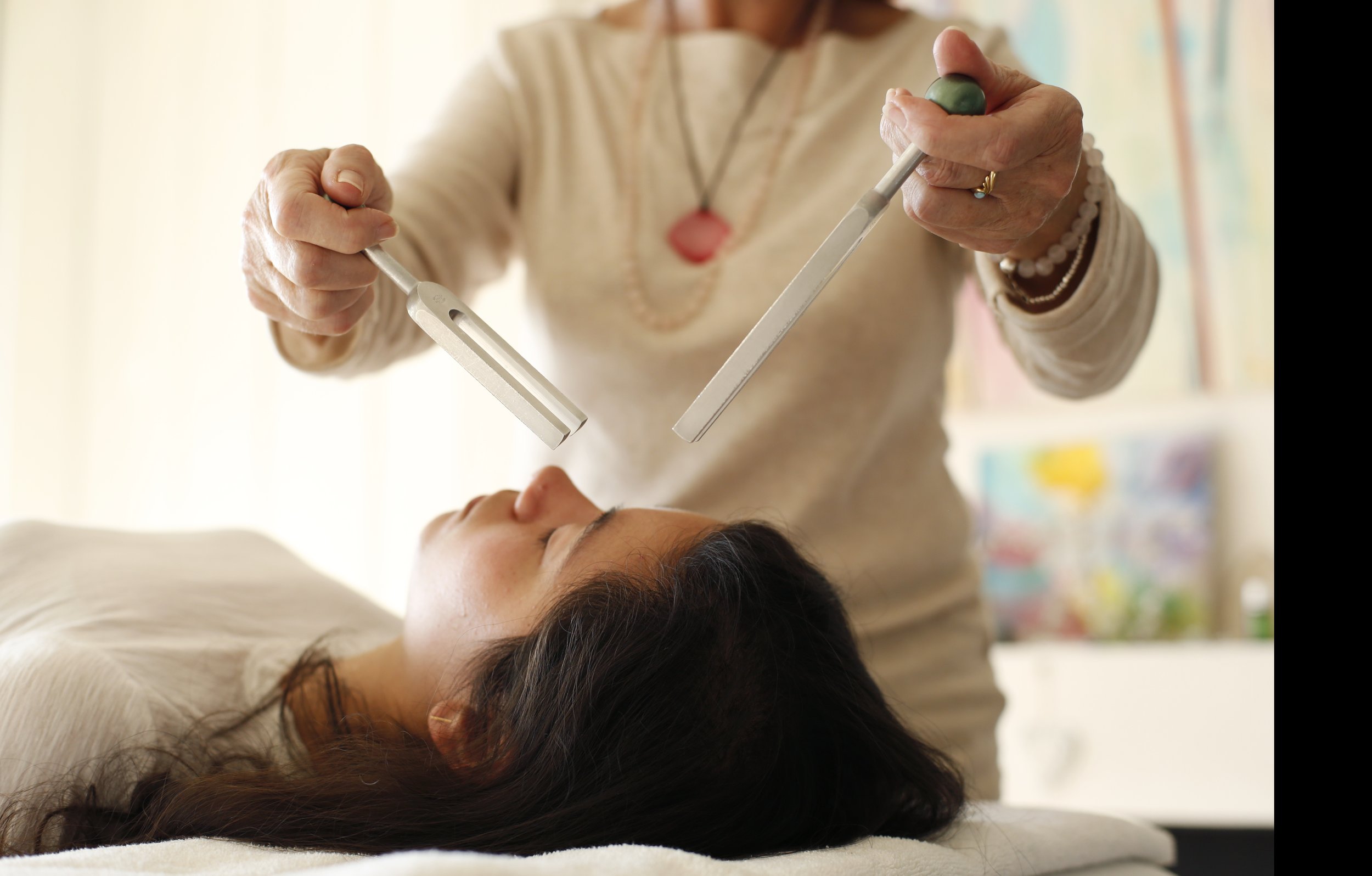 sound therapy biofield woman tuning fork relaxed