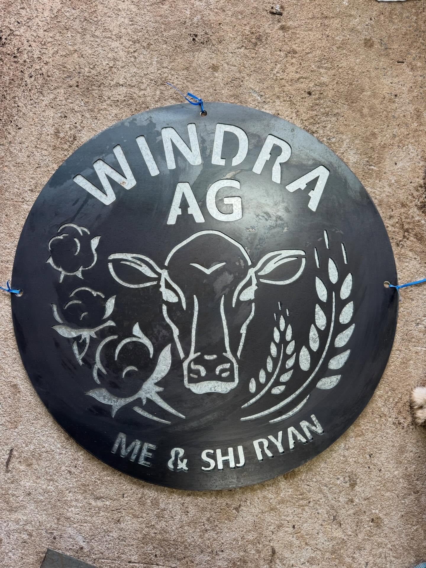 A really great logo on a round sign accompanied by two address plates!