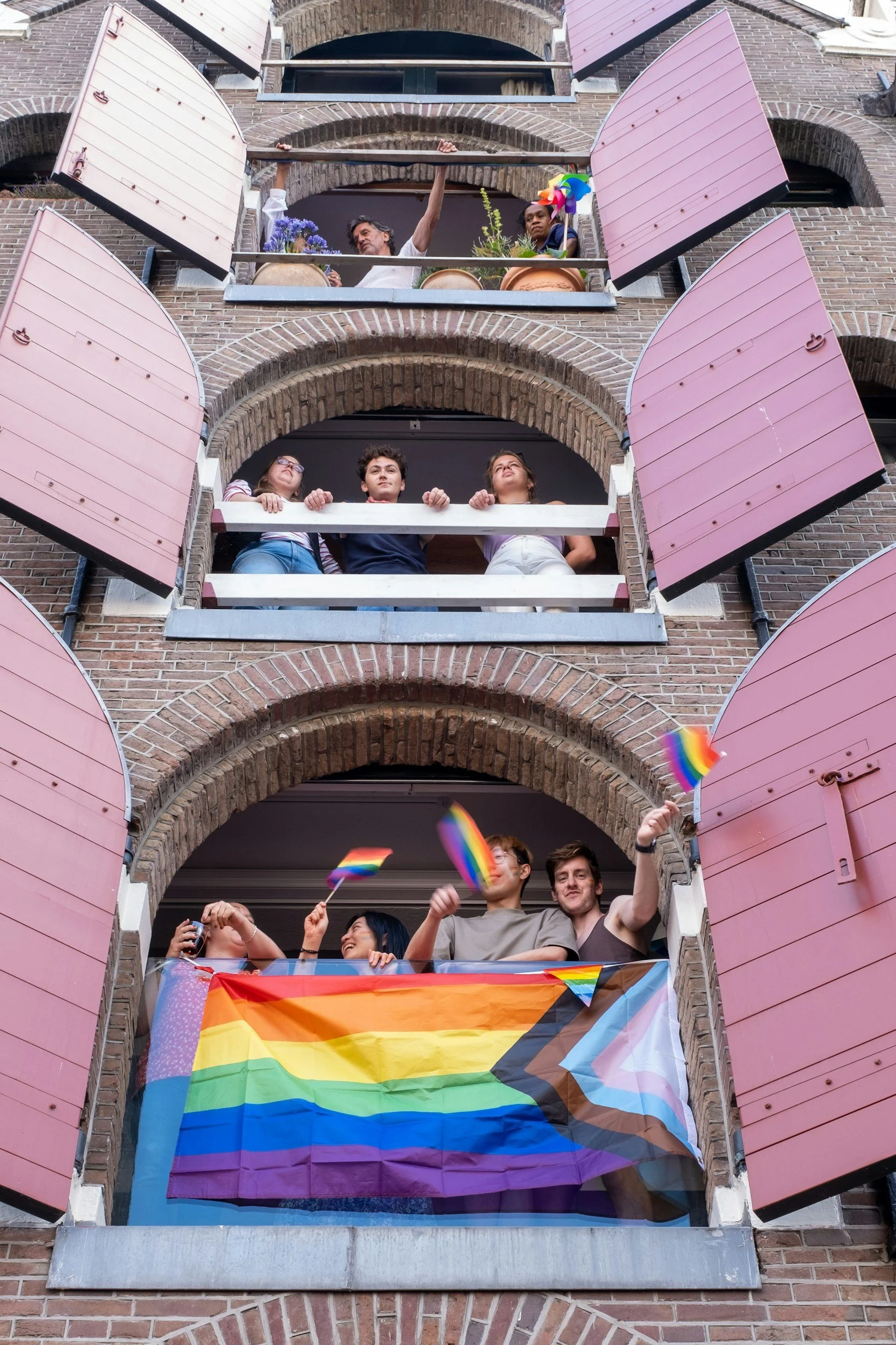 LGBTQIA+ pride flag against a blue sky