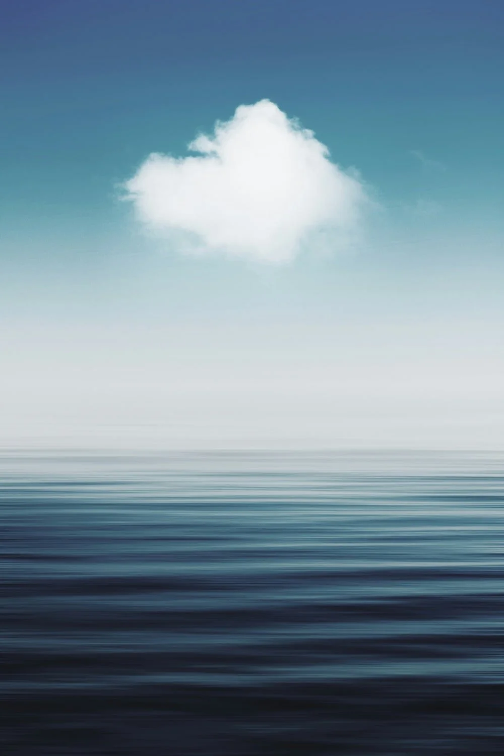 A single white cloud floating above a calm, still ocean — an image of quiet spaciousness and interior calm.