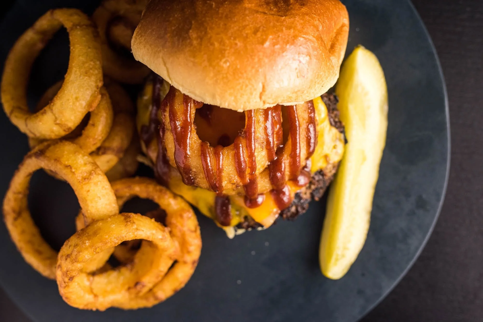 Blacksmith Burger: 1/3# burger, cherrywood bacon, cheddar cheese, black and tan onion ring and BBQ sauce