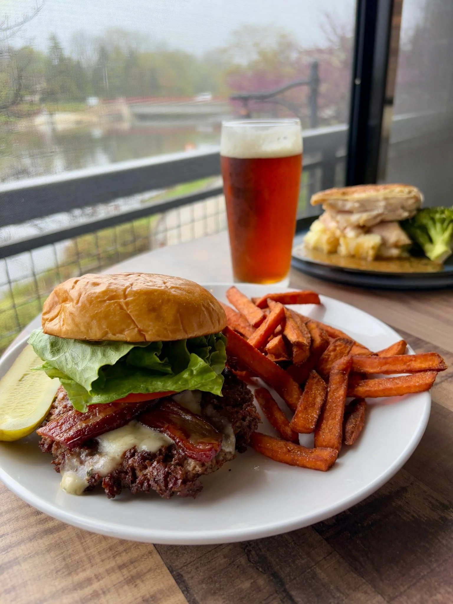 Bacon And Blue Burger 100% Brisket blend burger, Duroc bacon, lettuce, tomato, pickle, Carr Valley blue cheese