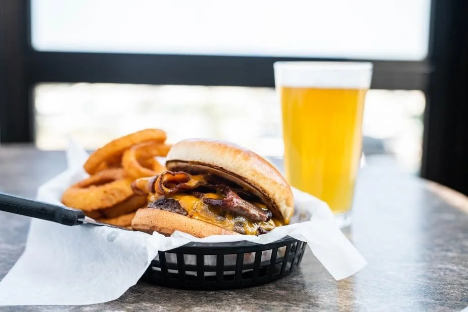WTF cheeseburger with crispy onion rings and a refreshing pint.