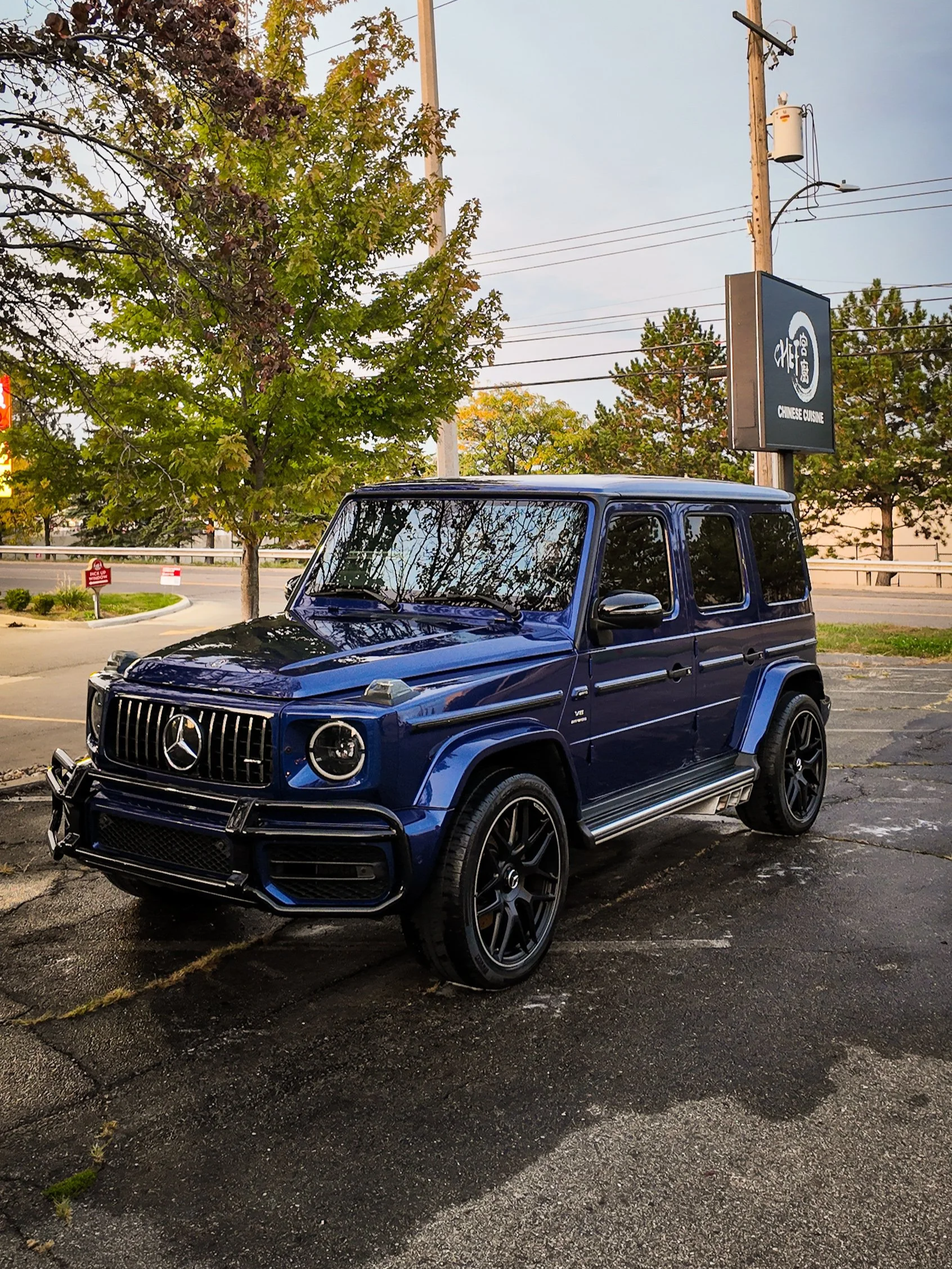 Incredible mirror-like reflections on a black Mercedes-Benz G-Wagon after a multi-stage paint correction and ceramic coating in Lansing, Michigan.