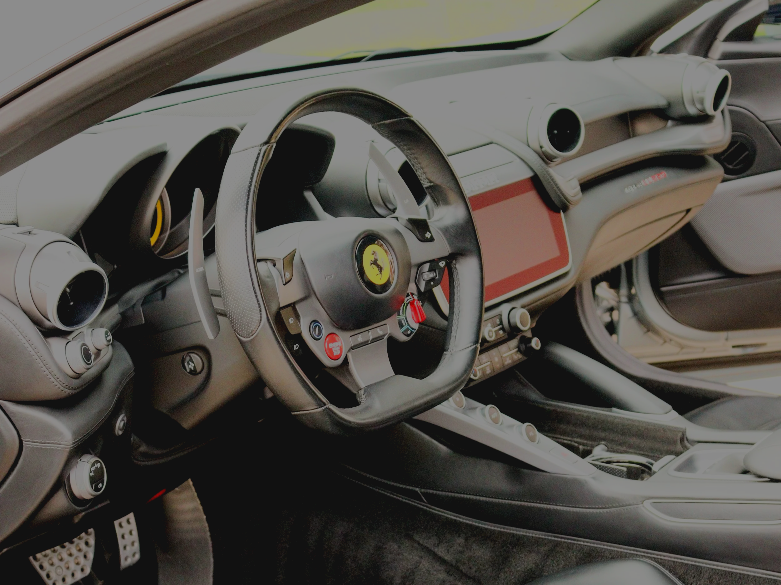 Deep cleaning and conditioning of Italian leather seats in a Ferrari GTC4Lusso. Professional interior detailing in Lansing, MI, using pH-balanced cleaners.