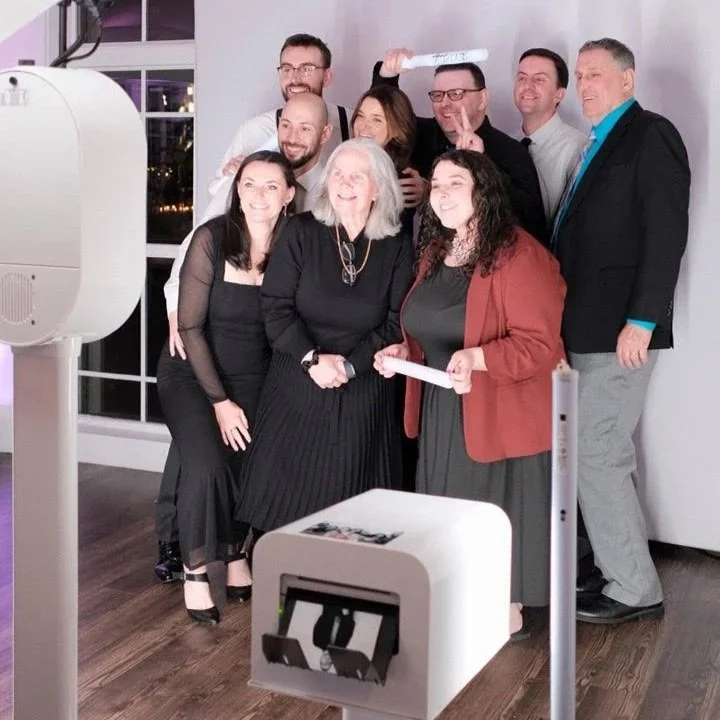 Guests posing at a wedding photobooth