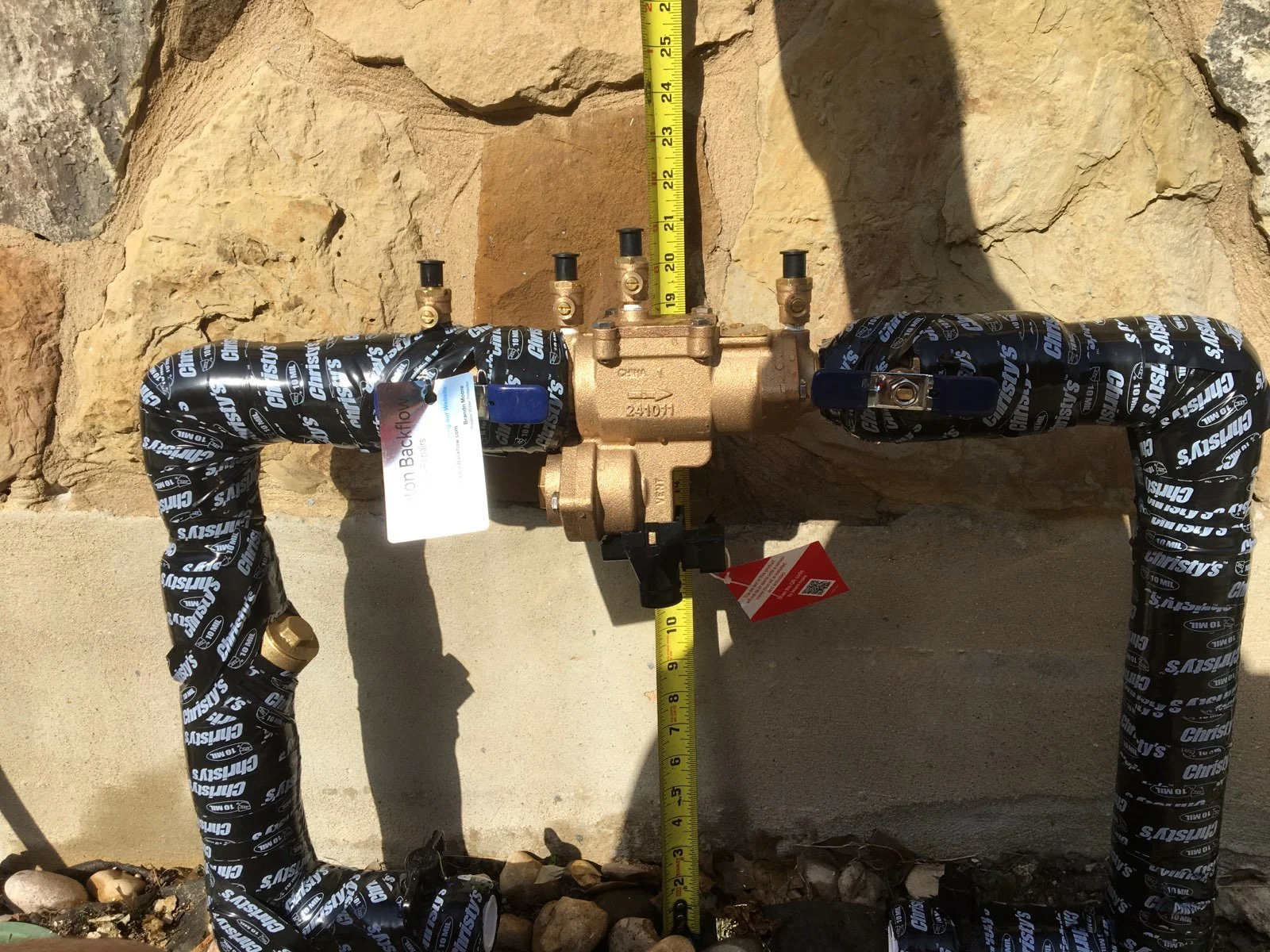 Backflow preventer being measured for correct fit.