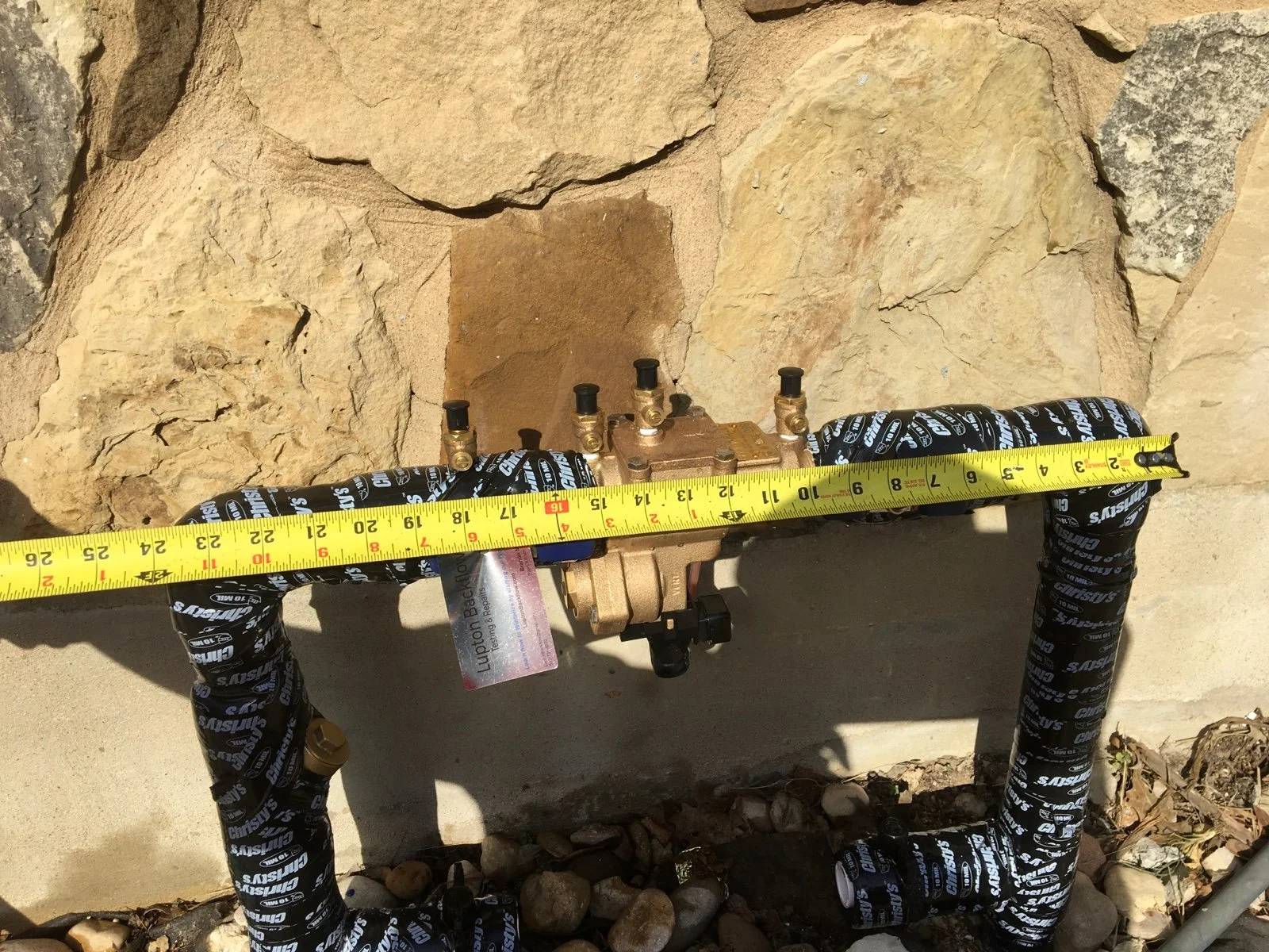 Backflow preventer being measured for correct fit.