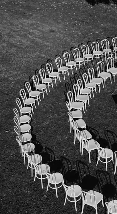 Wedding ceremony set up at Greyleigh in Kiama, beautifully arranged white chairs creating an intimate ceremony.