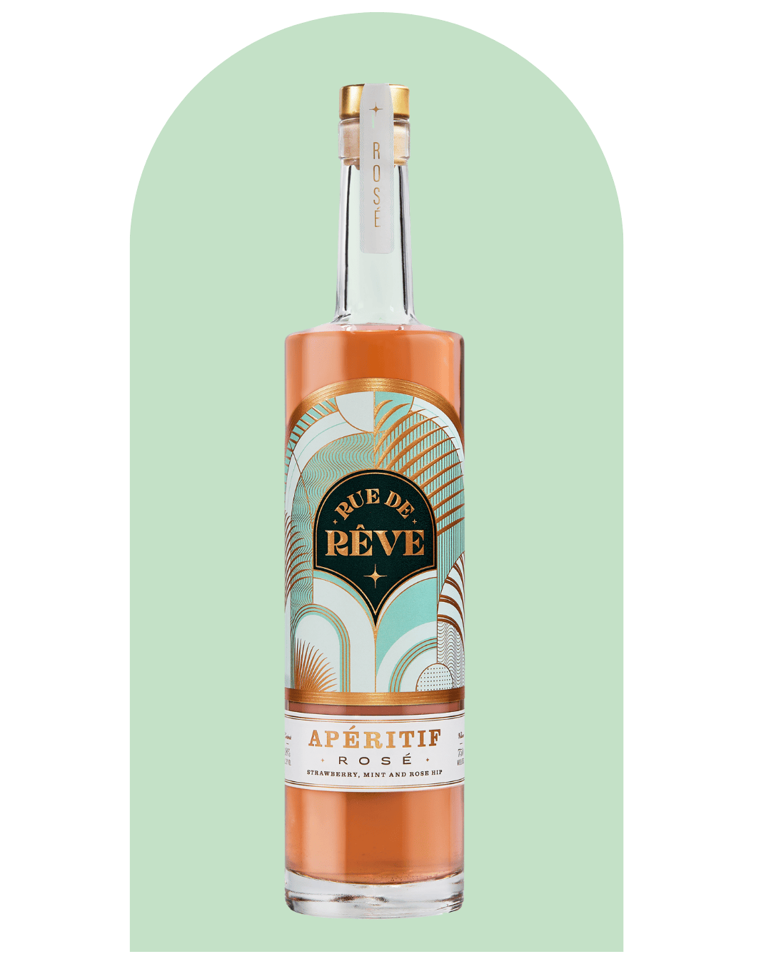 A tall glass bottle of Rue de Rêve Apéritif Rosé with pink liquid inside, featuring a decorative label with gold, black, and teal design elements, against a light green background with a rounded top design.