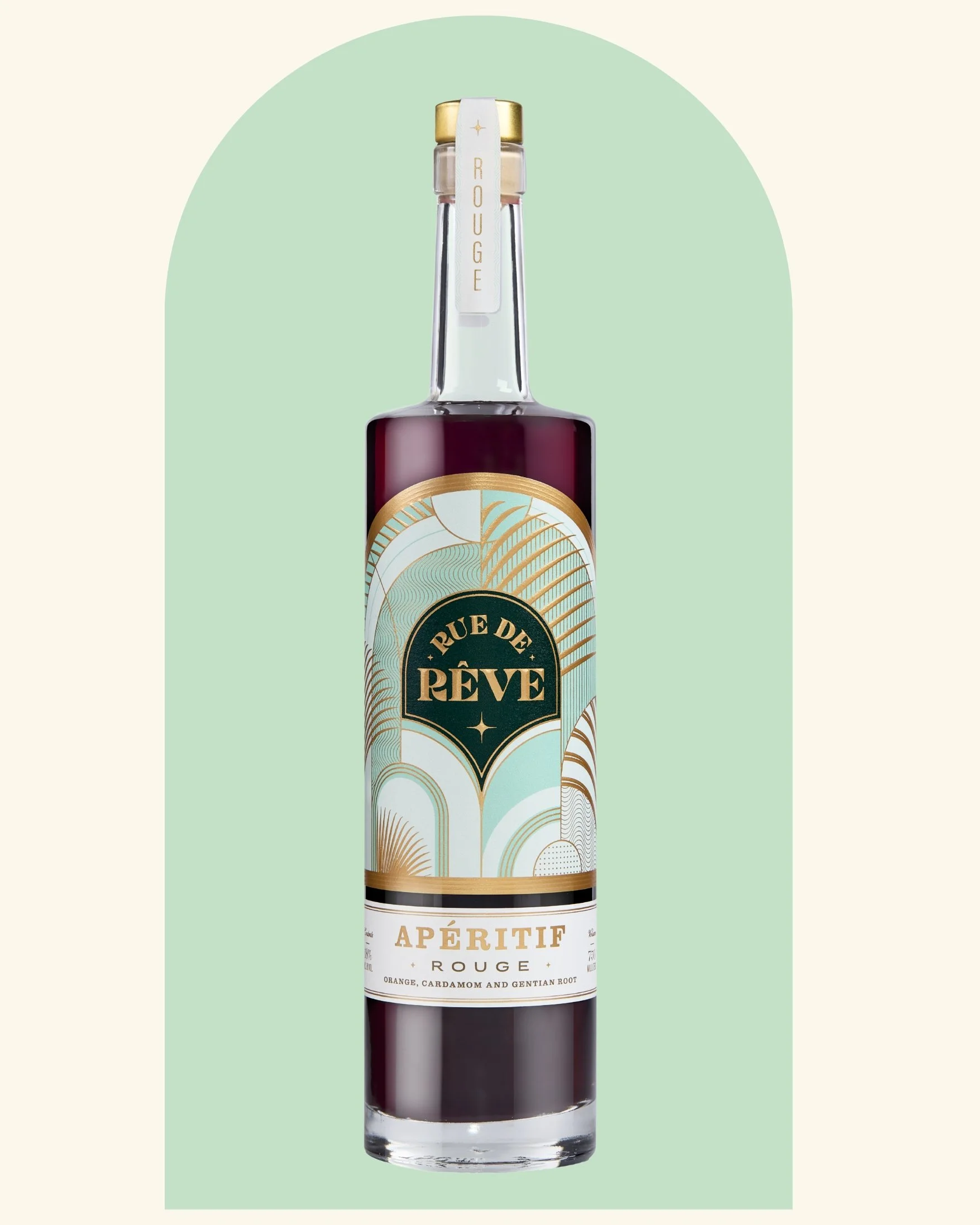 A bottle of Rue de Rêve Aperitif Rouge with an abstract design label, set against a light green background.