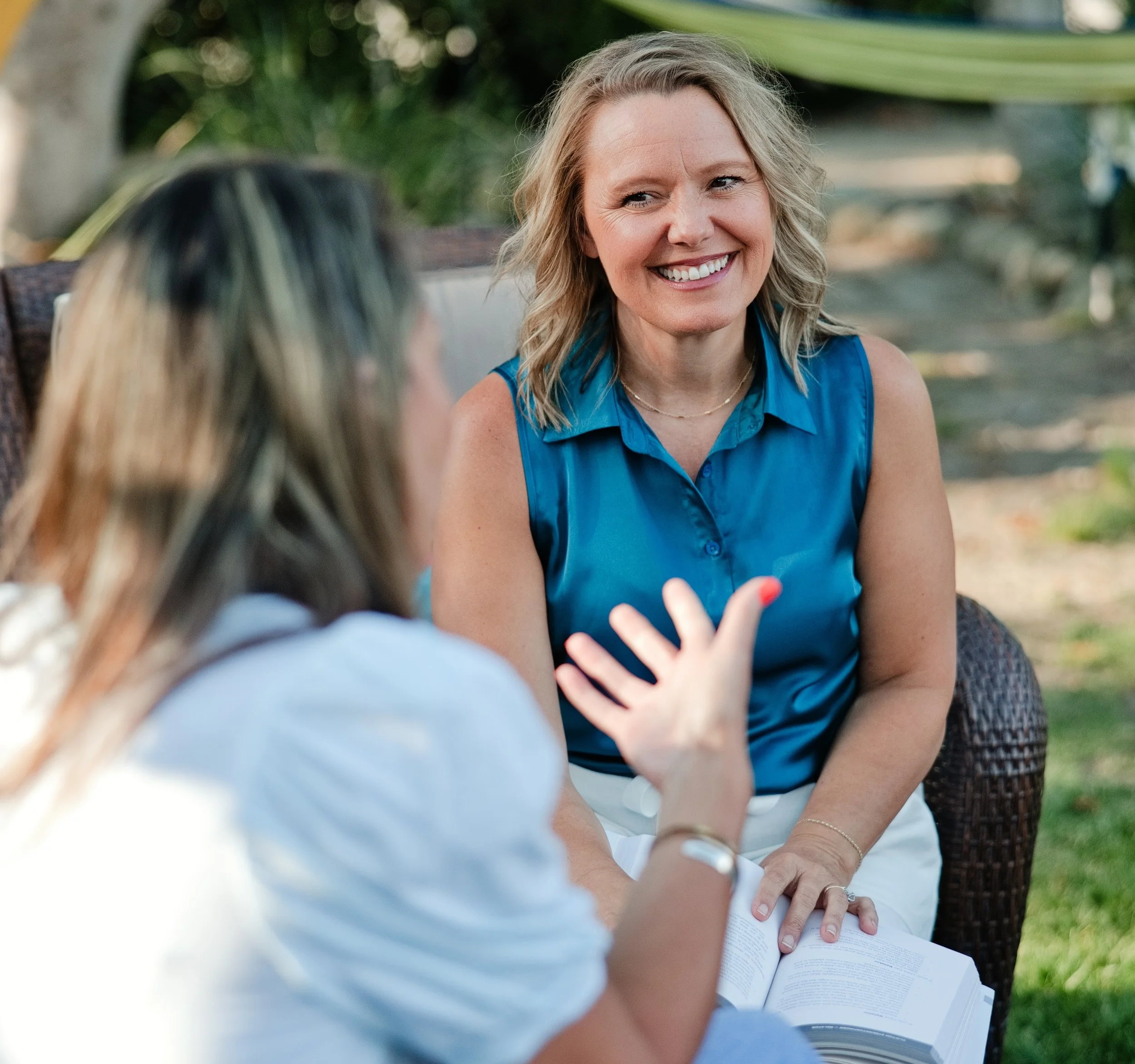 Whitney Scott sits in conversation with another woman