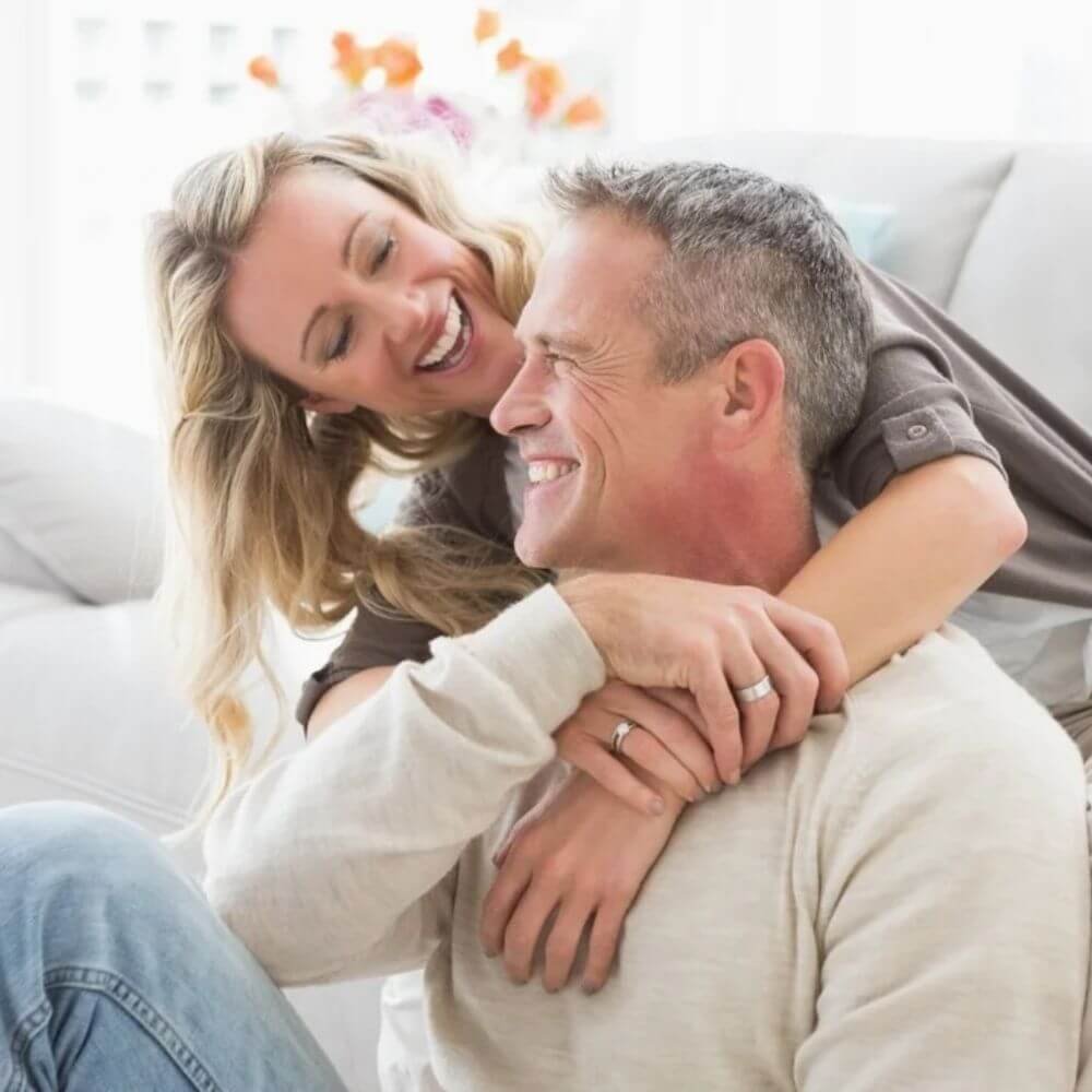 Renting Out Your House - The Partners (Smiling couple rental property owners relaxing at home)