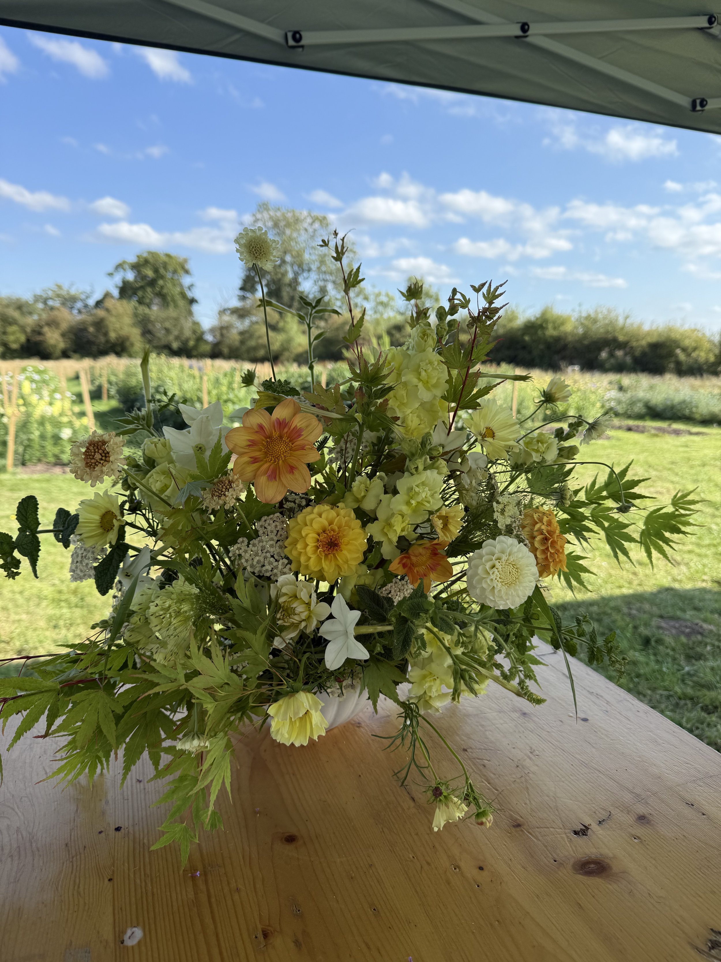 Seasonal bowl arrangement created on a Cheshire flower farm, featuring locally grown flowers and natural foliage.
