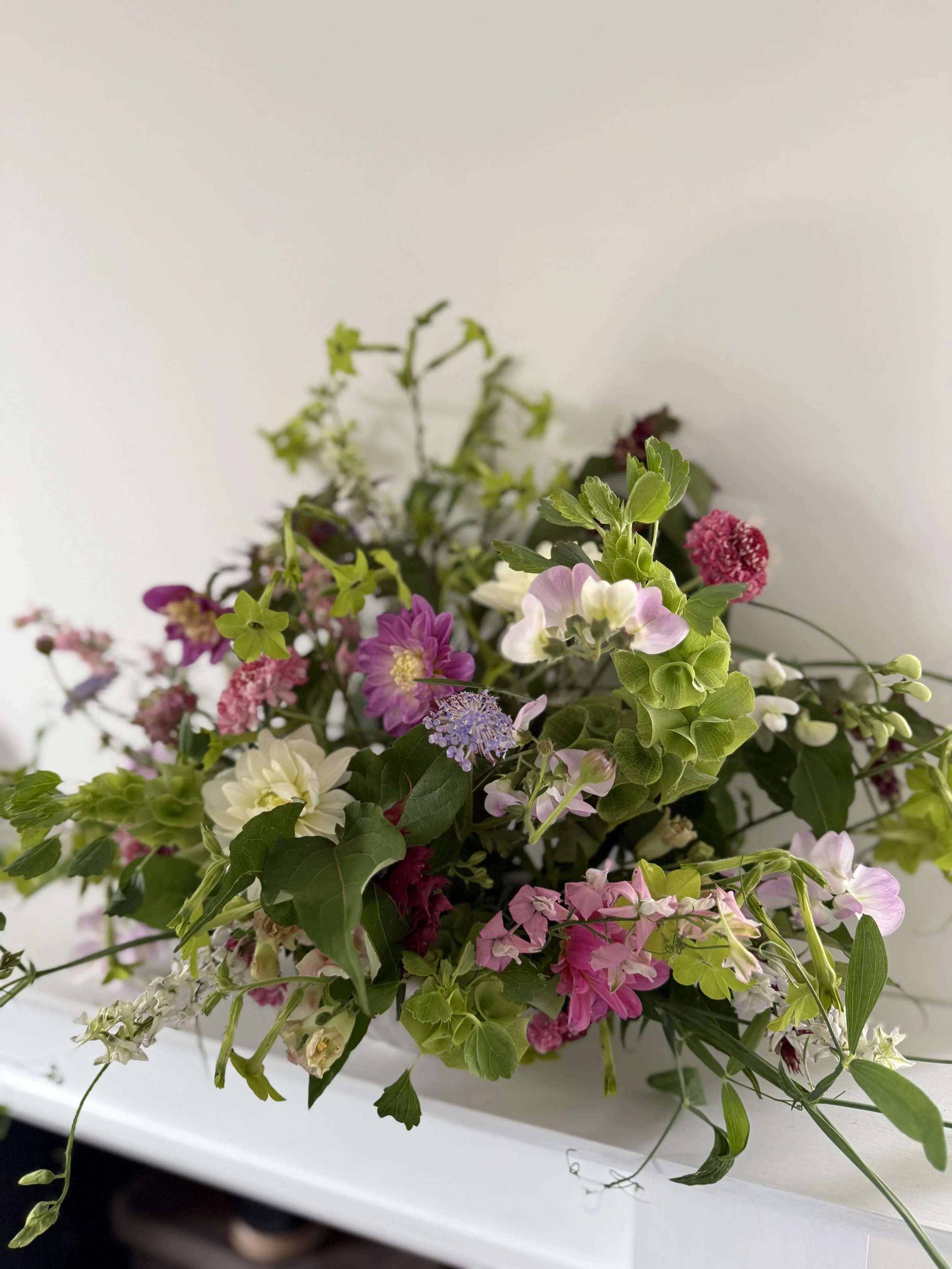 Seasonal bowl arrangement created on a Cheshire flower farm, featuring locally grown flowers and natural foliage.