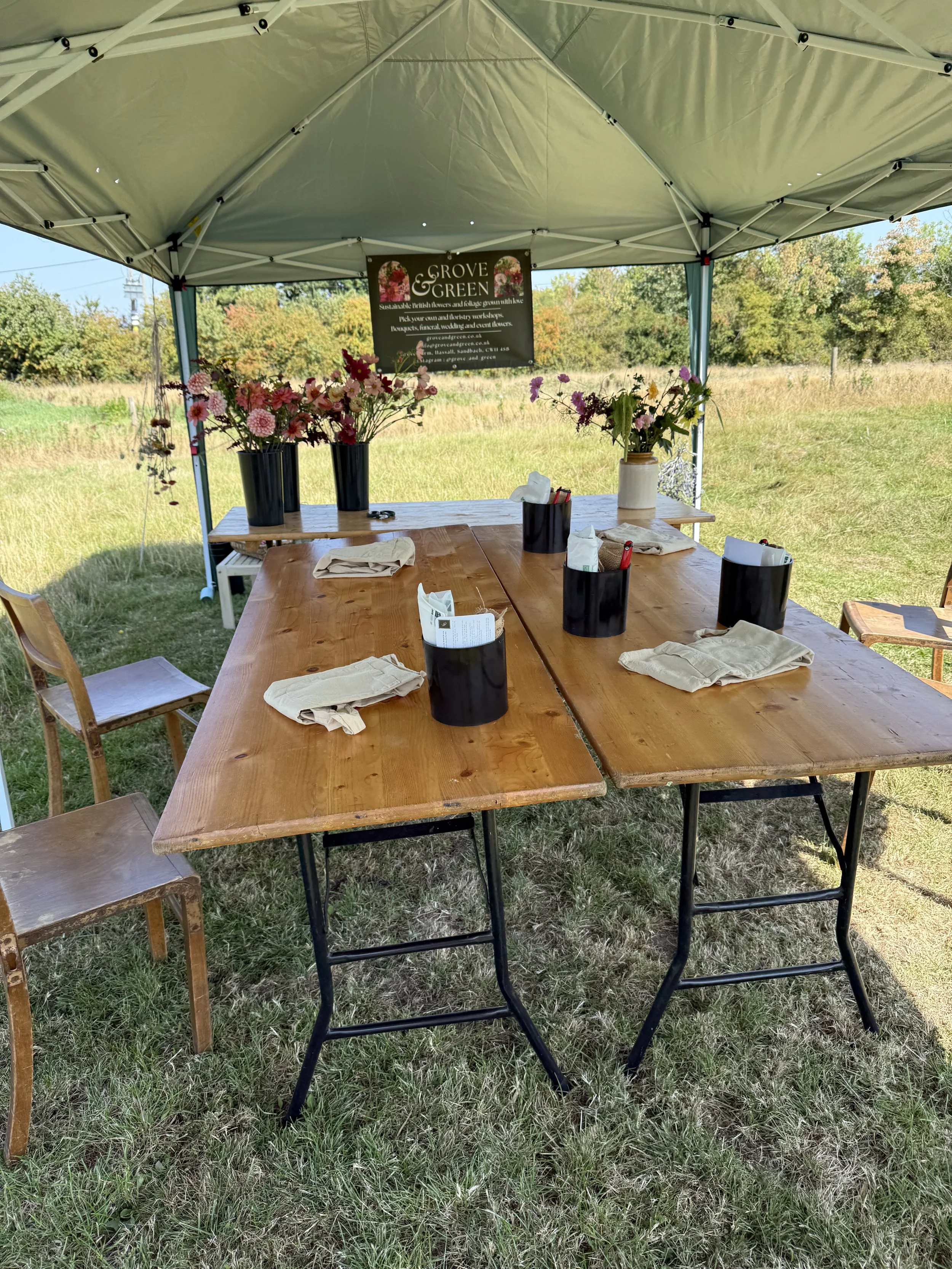 Flower farm workshop setup with tables prepared for bouquet making using seasonal British grown flowers.