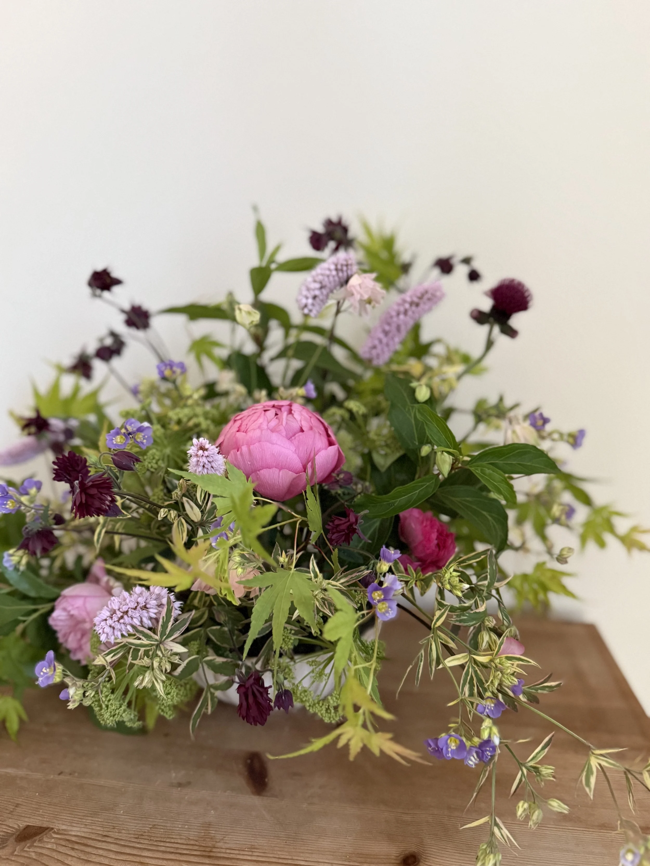 Seasonal bowl arrangement created on a Cheshire flower farm, featuring locally grown flowers and natural foliage.