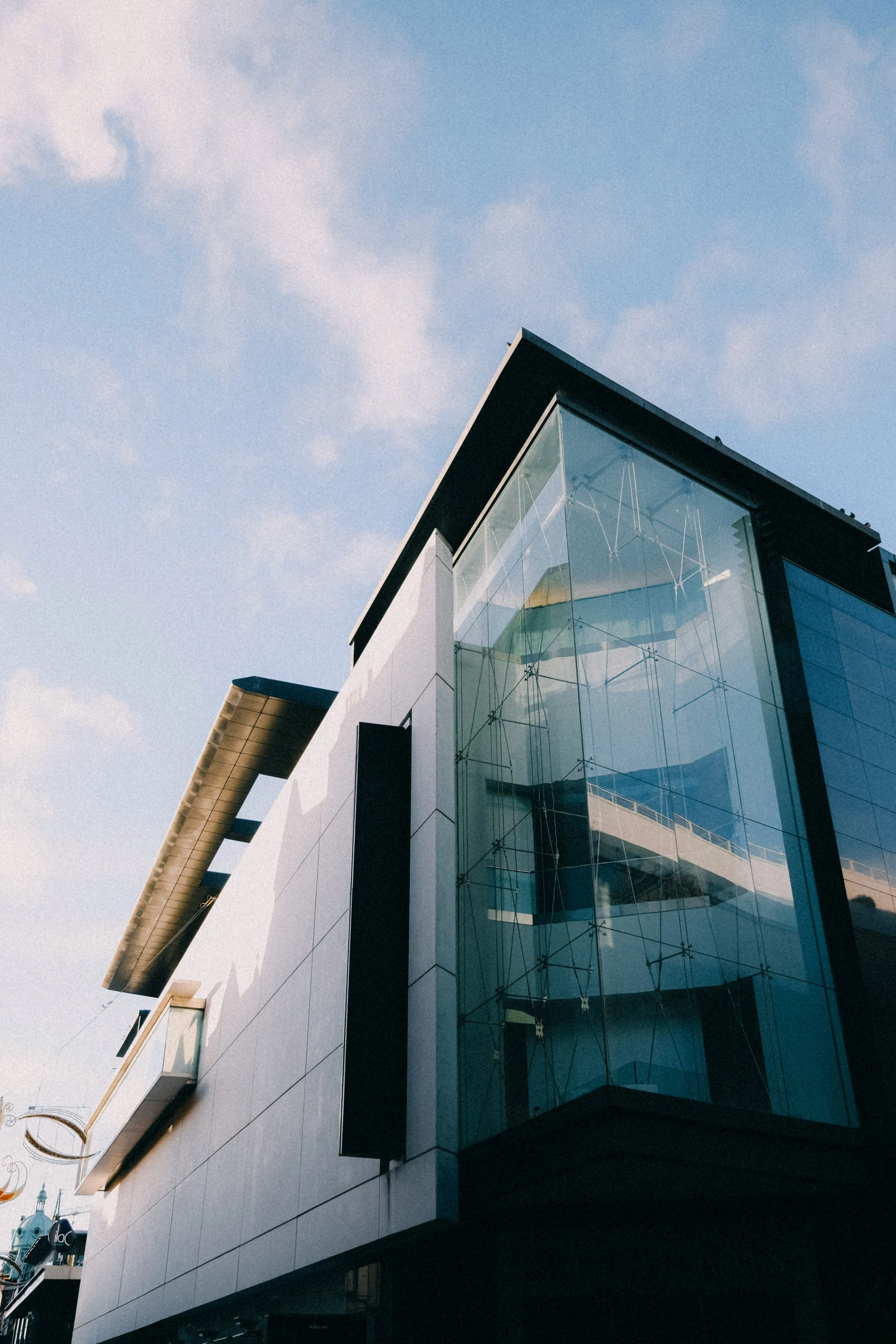 Modern building with glass and steel architecture against blue sky