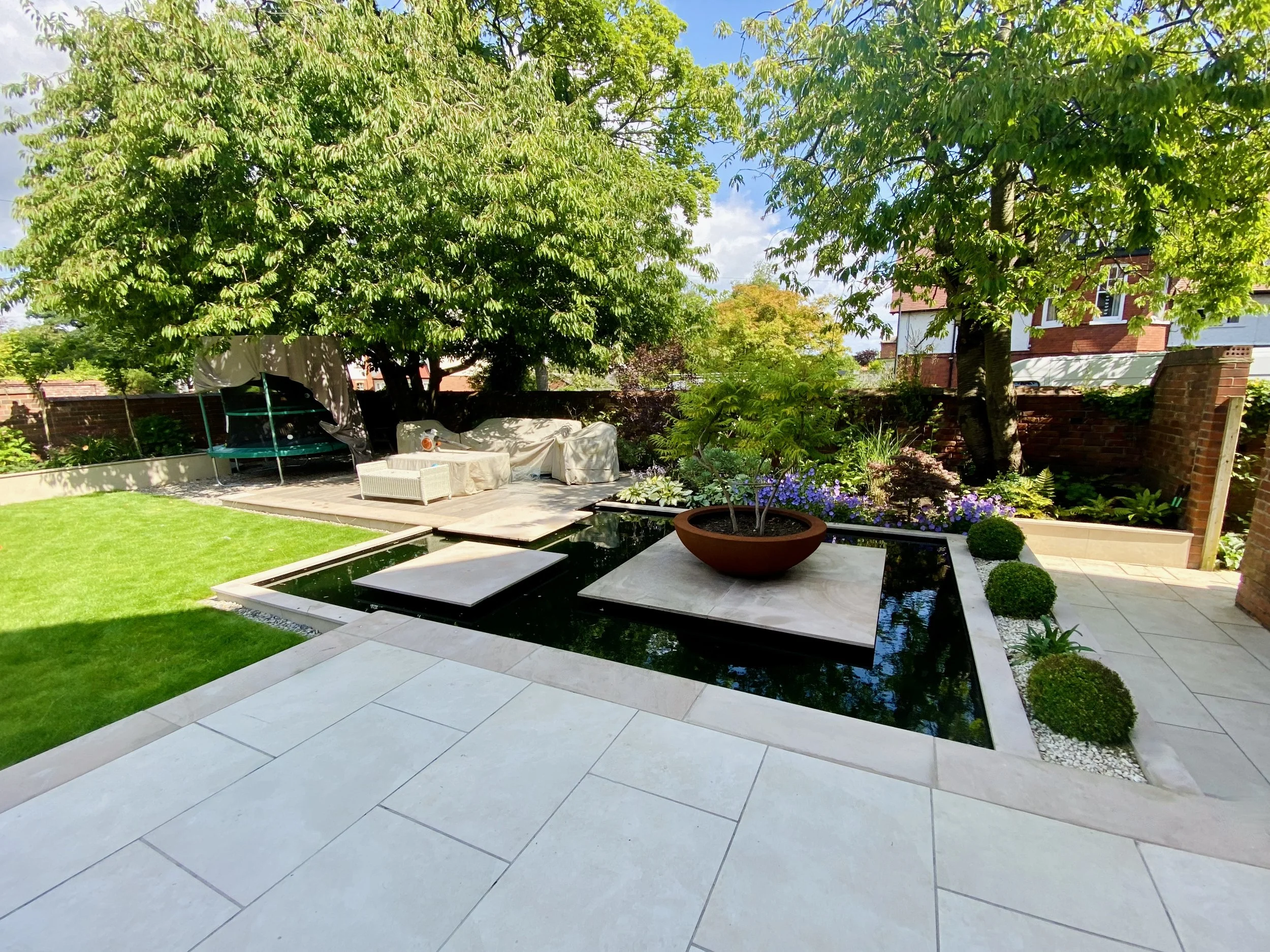 A photograph of the reflecting pool with oversize stepping stone islands linking the main patio and al fresco dining area