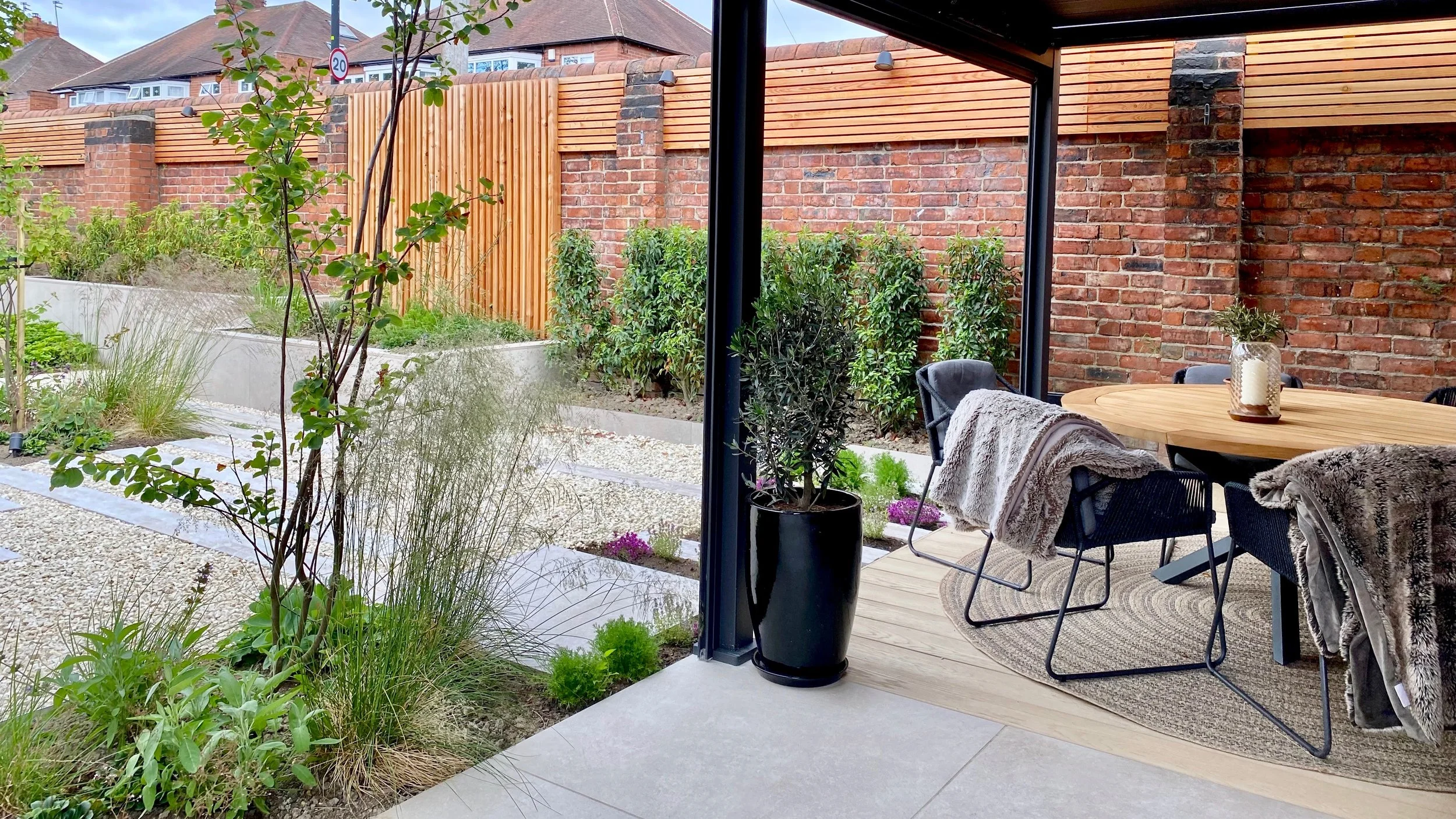An image showing the outside dining area under a pergola