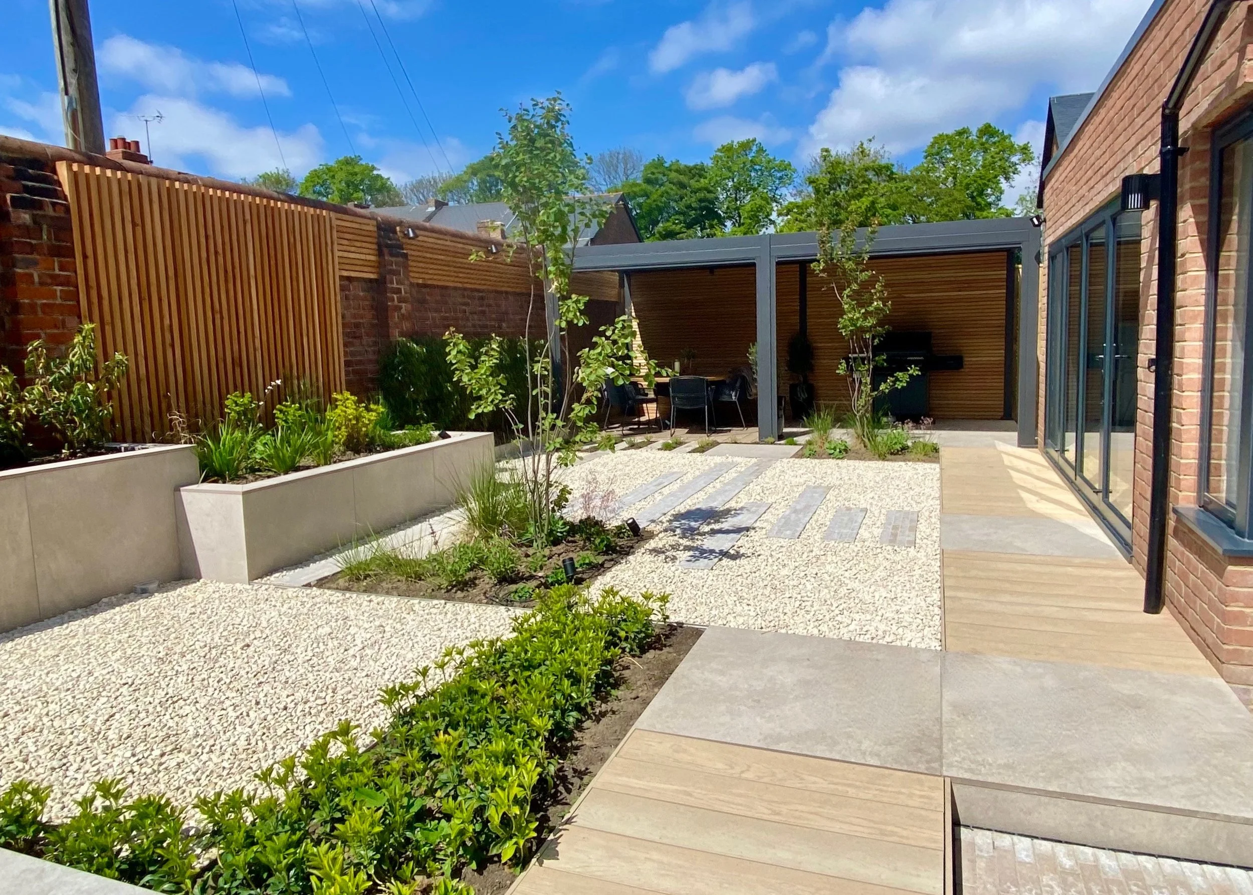 An image showing looking down the garden to the outside dining area