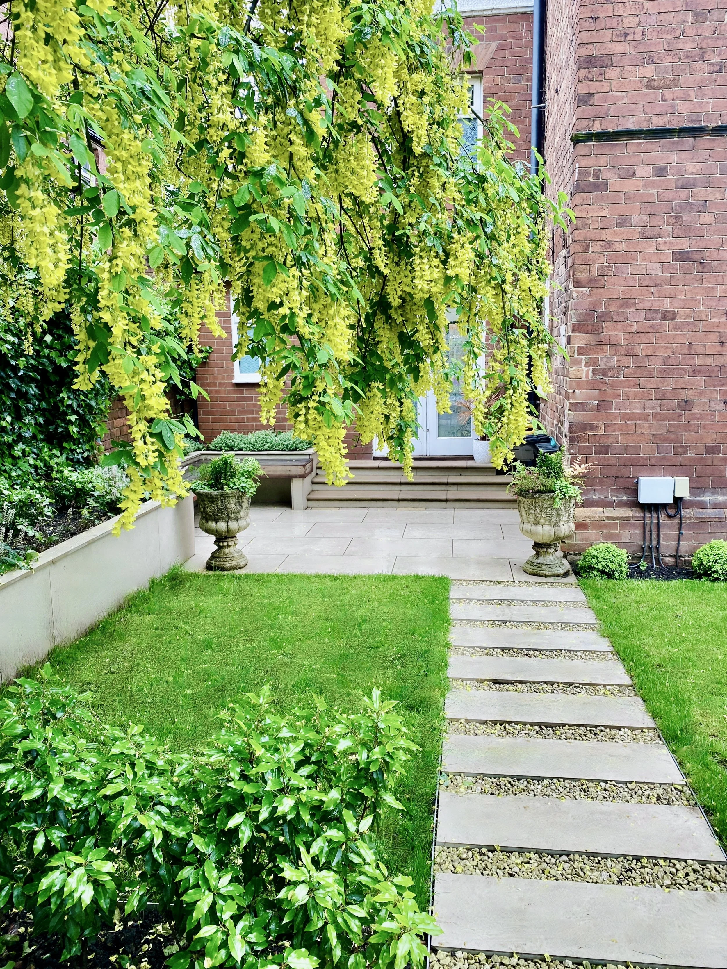 A stepping stone path leading to the private side garden