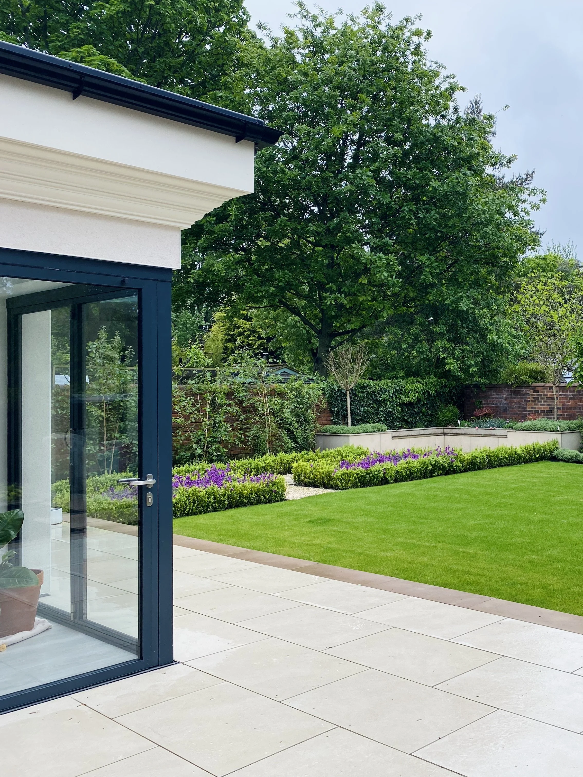 A photograph of the new garden looking towards an corner seating area