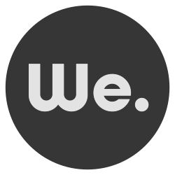 Close-up of a black circular logo with the word 'We.' in gray text.