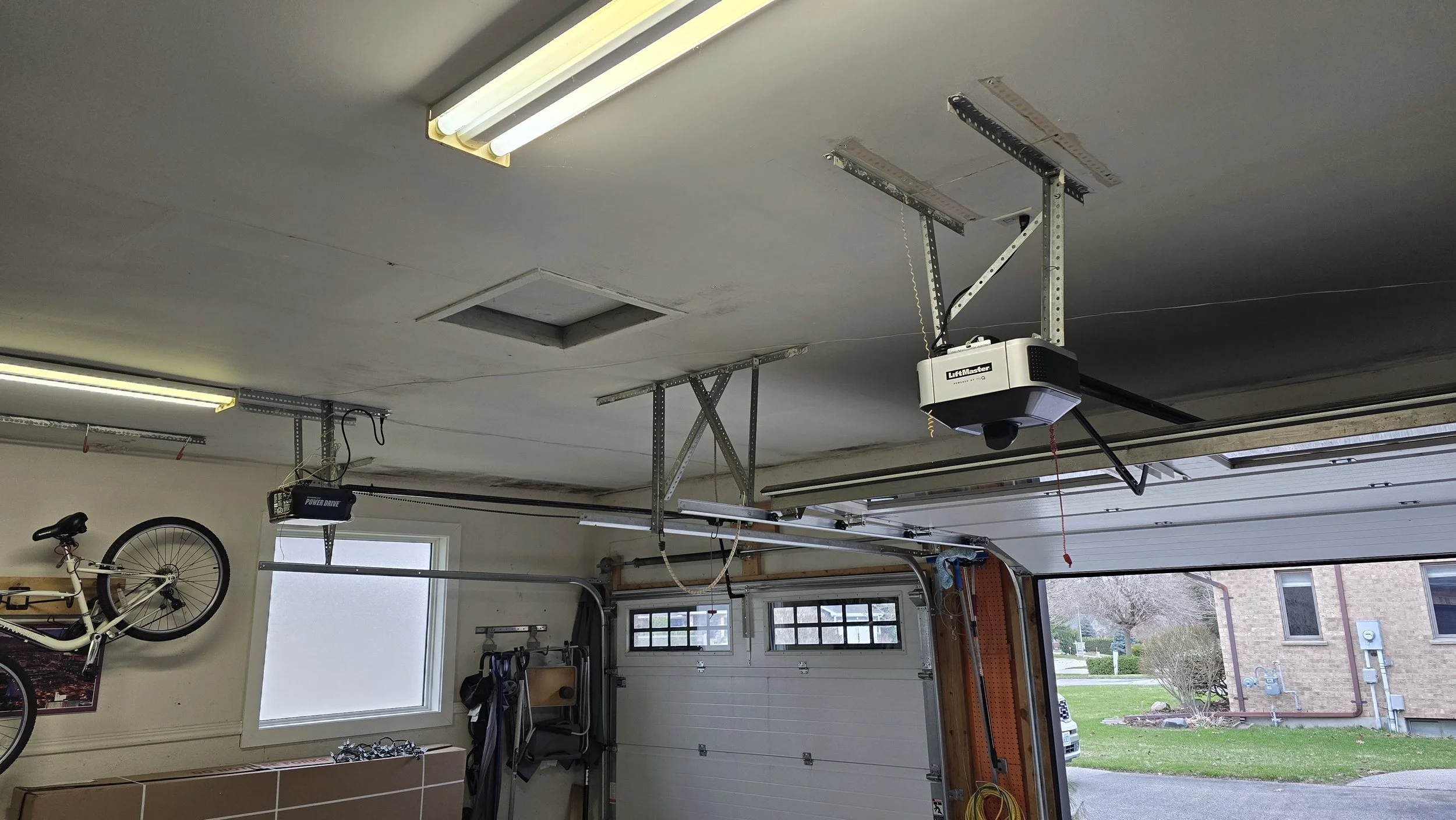pre-renovation picture of garage showing damage to drywall due to moisture issues caused by no ventilation,  isnsulation, wrong drywall and wrong paint choices.