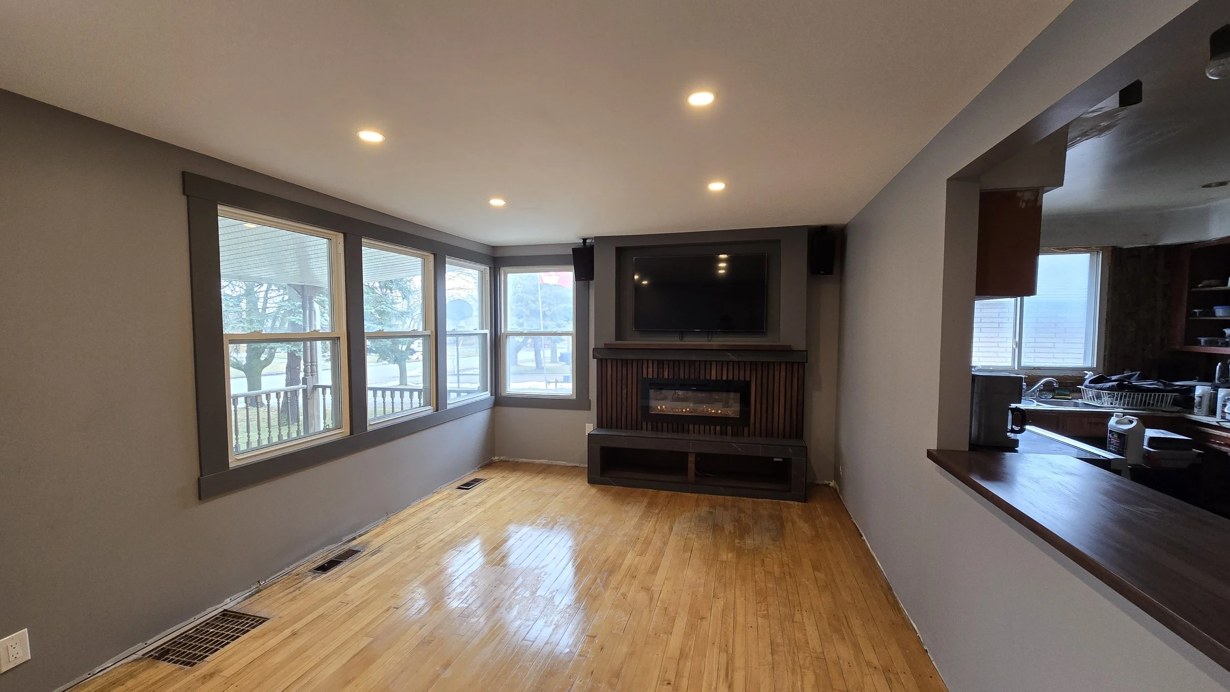This image shows a recent family room remodel with custom feature wall and entertainment center