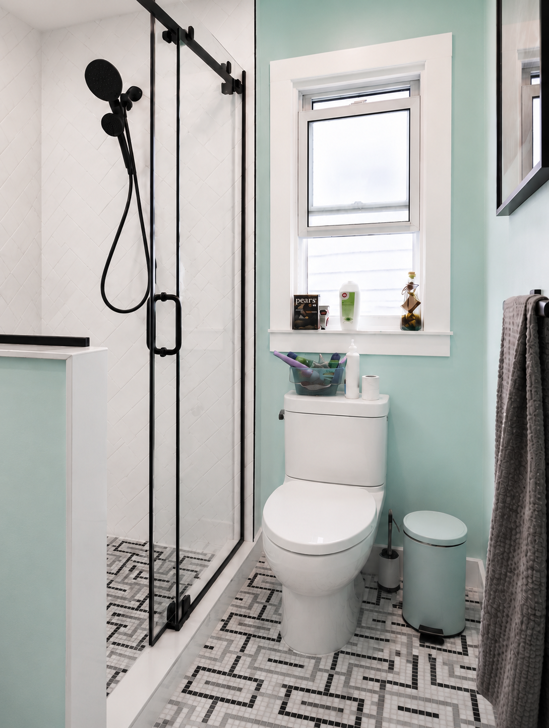 Black and White mosaic tile compliments the shower's white subway tile