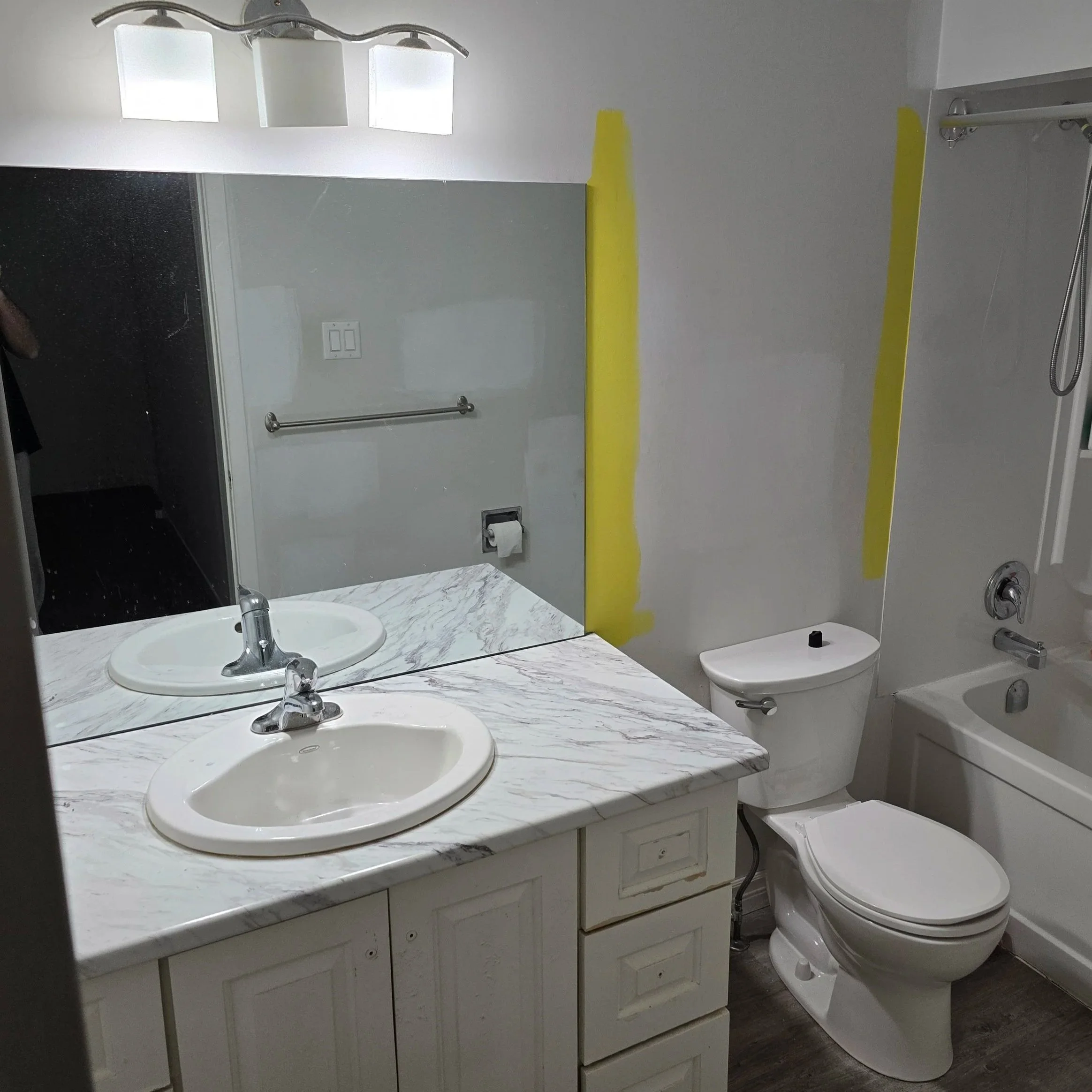 Before bathroom remodel featuring a water-damaged MDF vanity, aging drywall, outdated lighting, and moisture-prone finishes before restoration in London, Ontario.