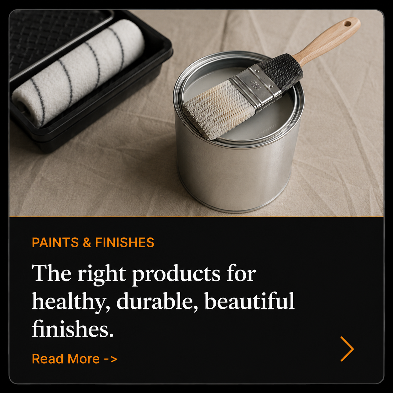 Paint brush resting on an open paint can beside a roller tray, illustrating quality painting products and durable interior finishes.