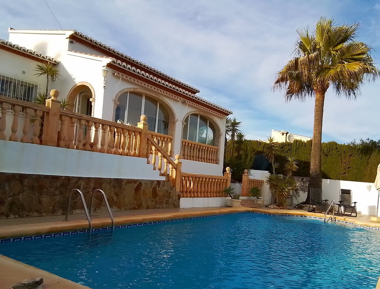 Mediterranean villa with swimming pool and palm tree