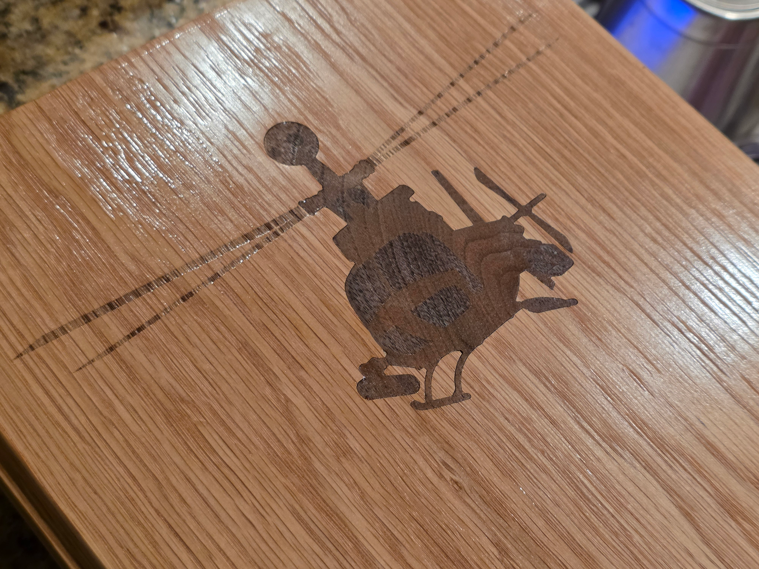 A wooden helicopter inlayed into white oak