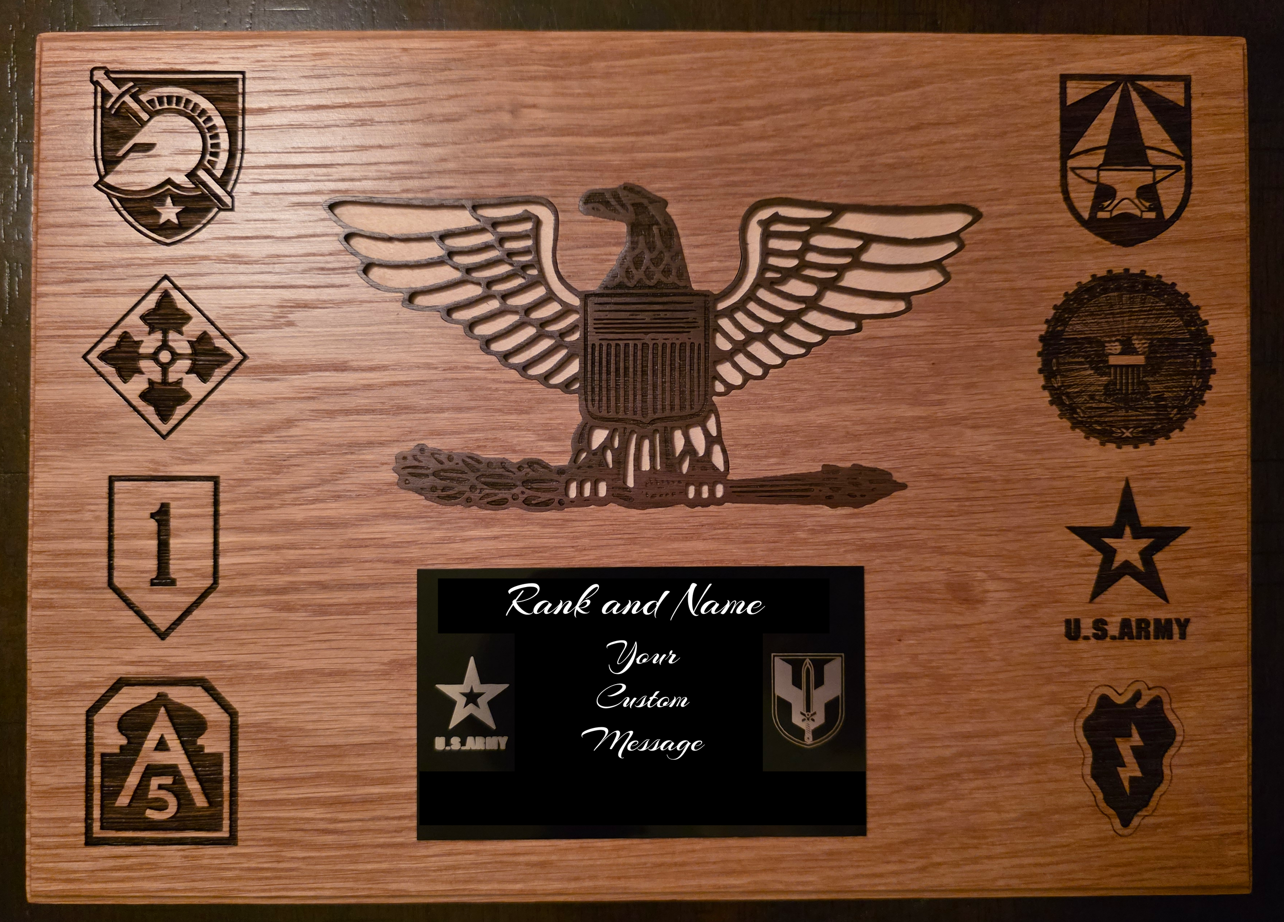 Wooden plaque with military-themed embossings and engravings, including a shield, star, and eagle symbols.
