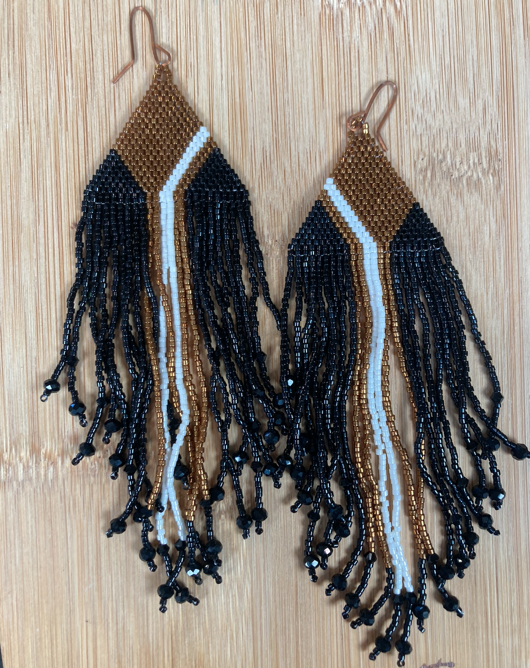 Fancy beaded black, gold and white fringe earrings