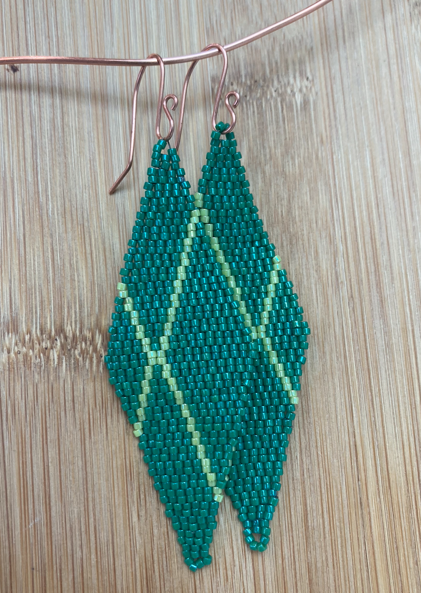 Woven green diamond earrings with X