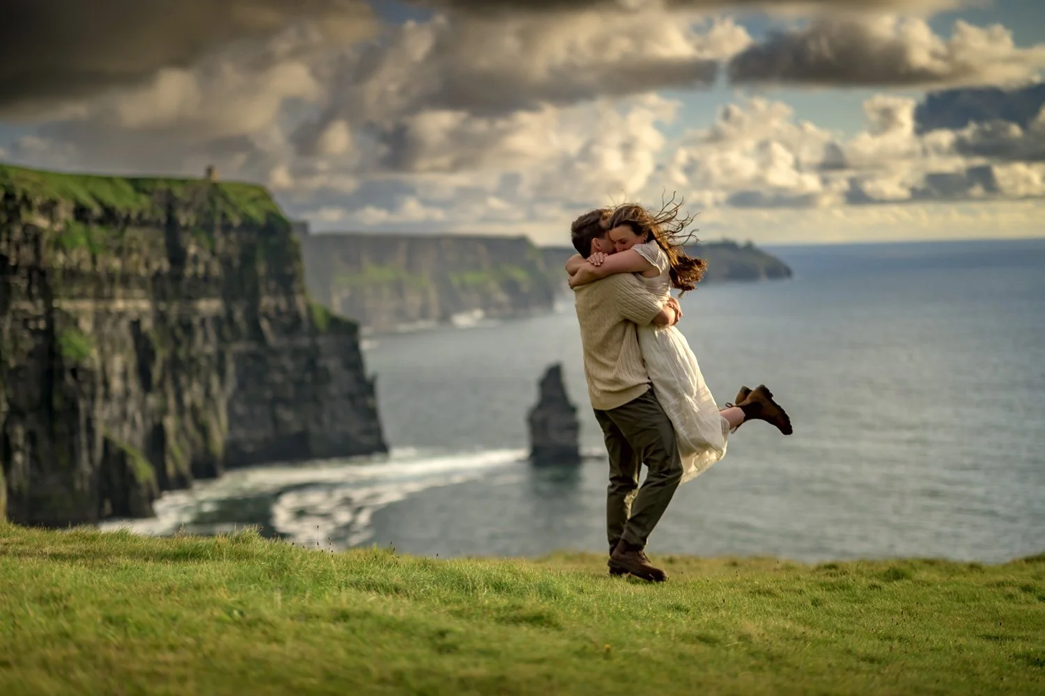 Joyful embrace after a successful marriage proposal at the Cliffs of Moher, captured as part of a surprise proposal package.