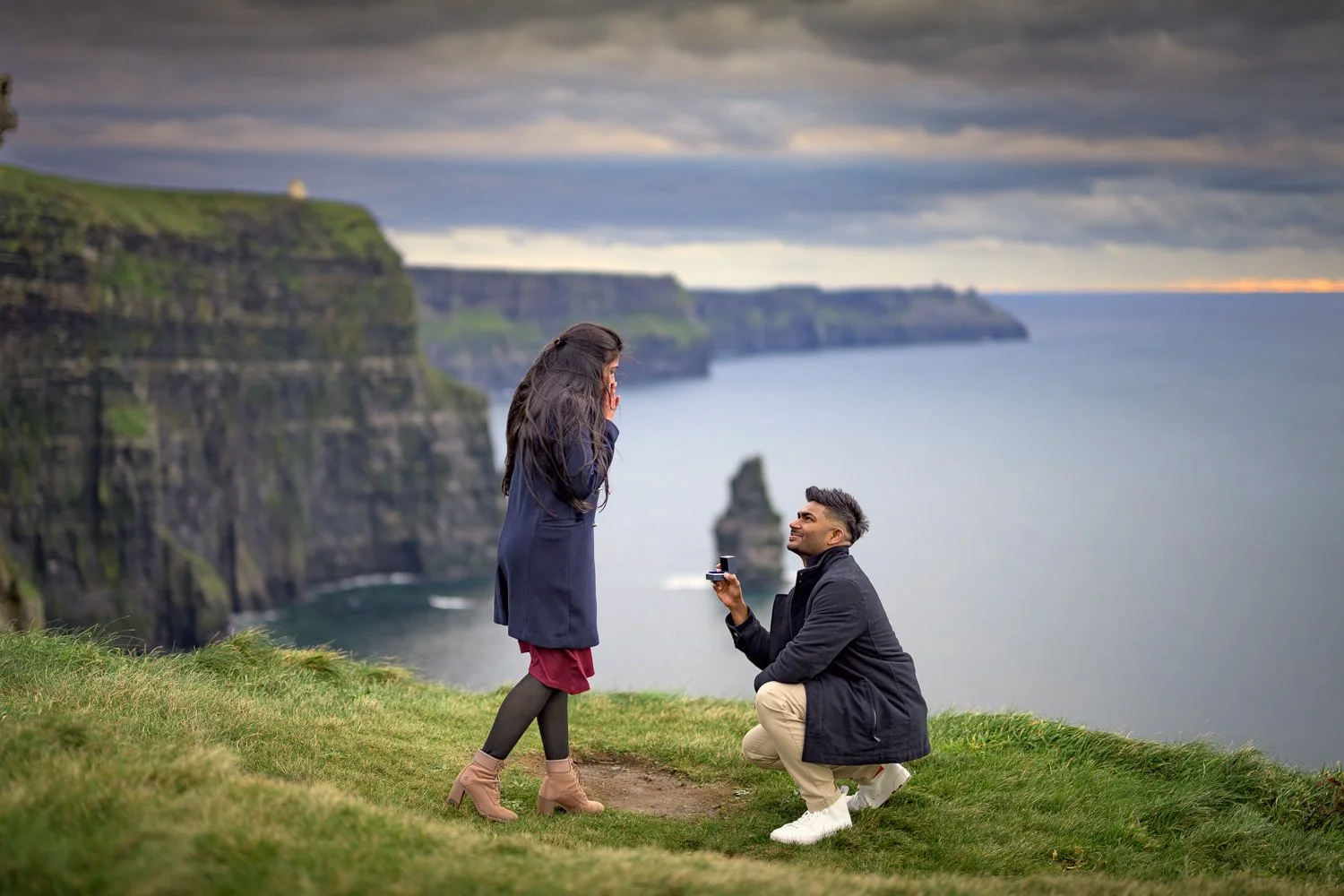 Surprise marriage proposal moment captured by a Cliffs of Moher proposal photographer with dramatic cliffside views.