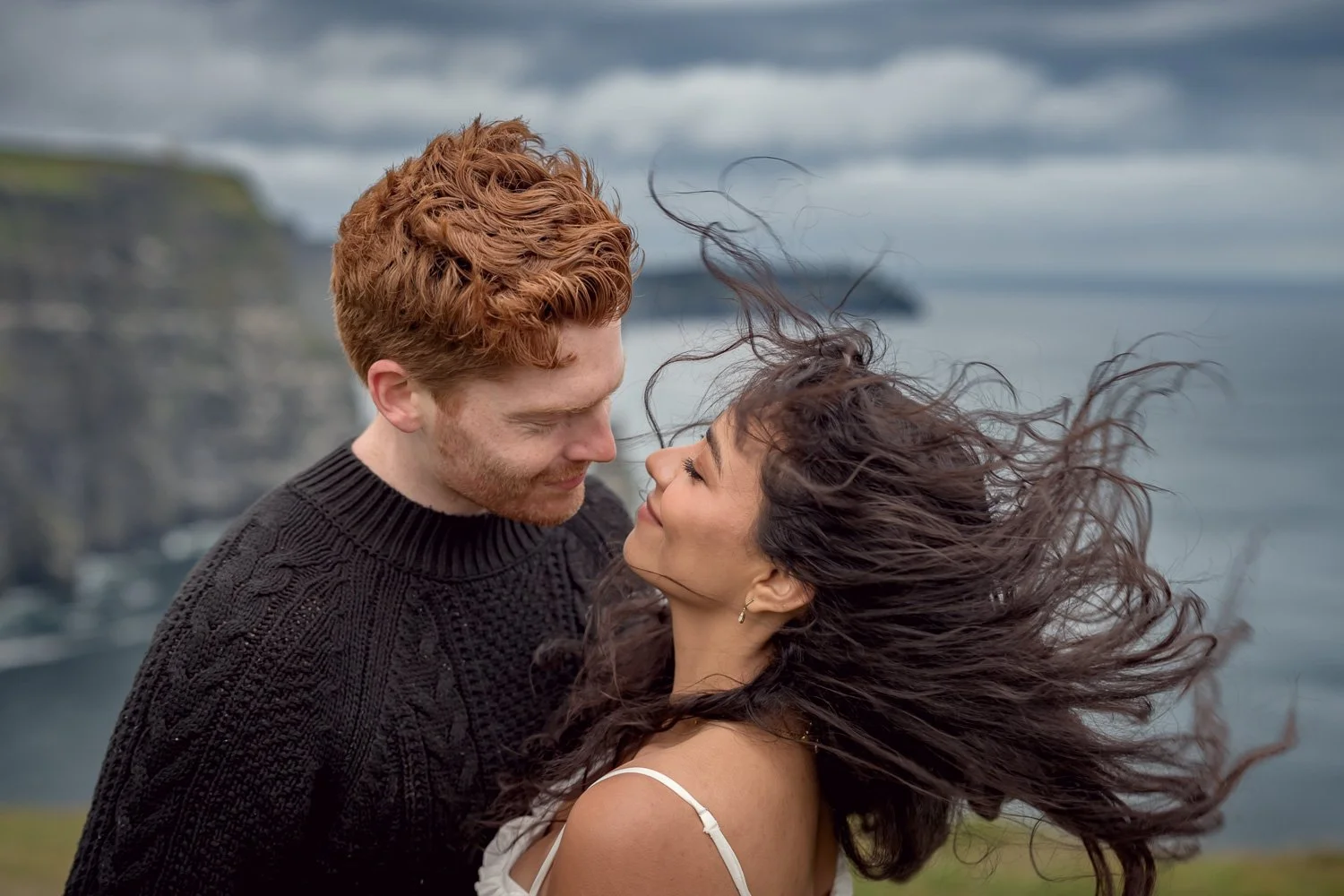 Bride-to-be smiling during an engagement proposal photo session at the Cliffs of Moher