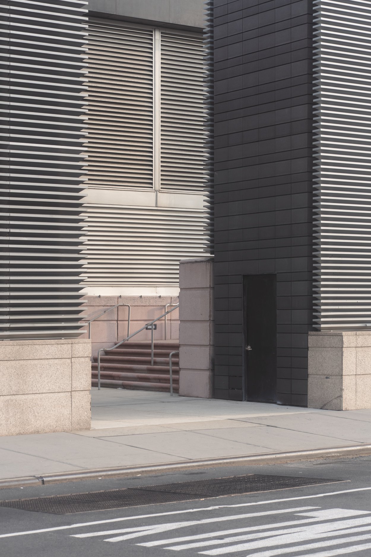 Modern building white and black exterior with metal louvers and stairs