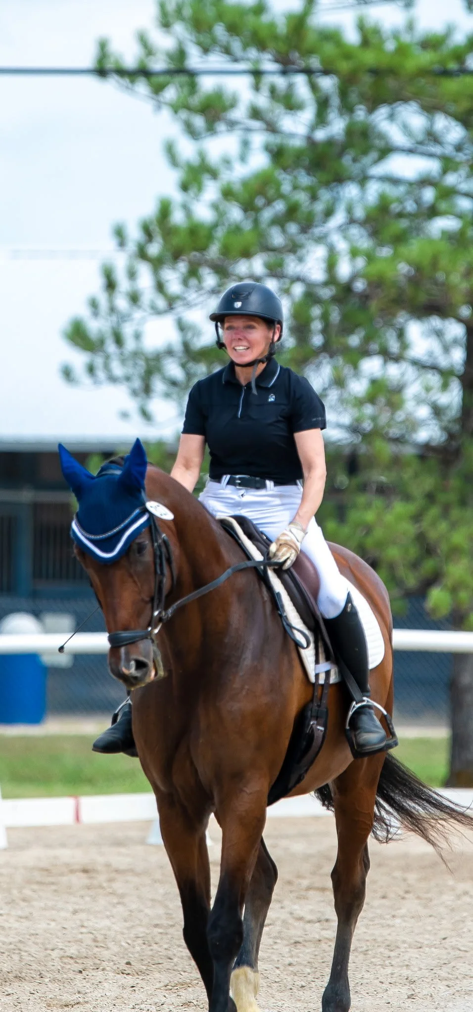 A woman riding a horse in an outdoor arena wanting to continue her active lifestyle after a fragility fracture.