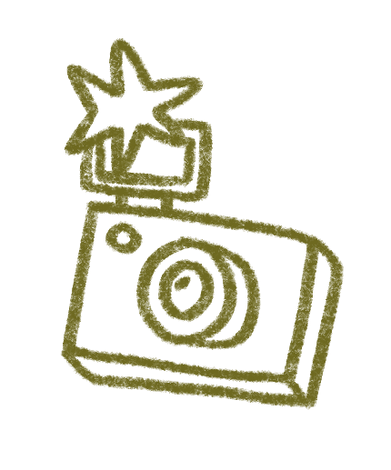 Dibujo de una cámara de fotos con una estrella o explosión sobre ella.
