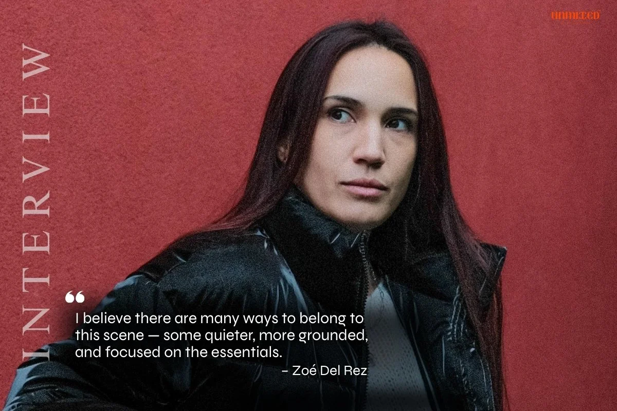 DJ ZOE DEL REZ from PAris France , A woman with long dark brown hair wearing a black puffer jacket against a red background, looking to the side. Text on the image includes a quote and the website 'INTERVIEW'.