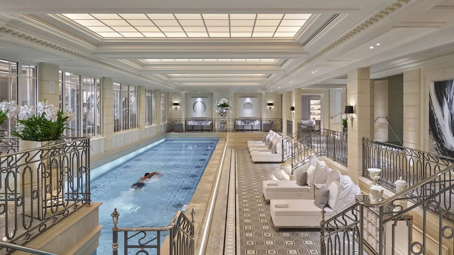 17-meter indoor swimming pool lined with plush loungers at Four Seasons Hotel George V Paris spa