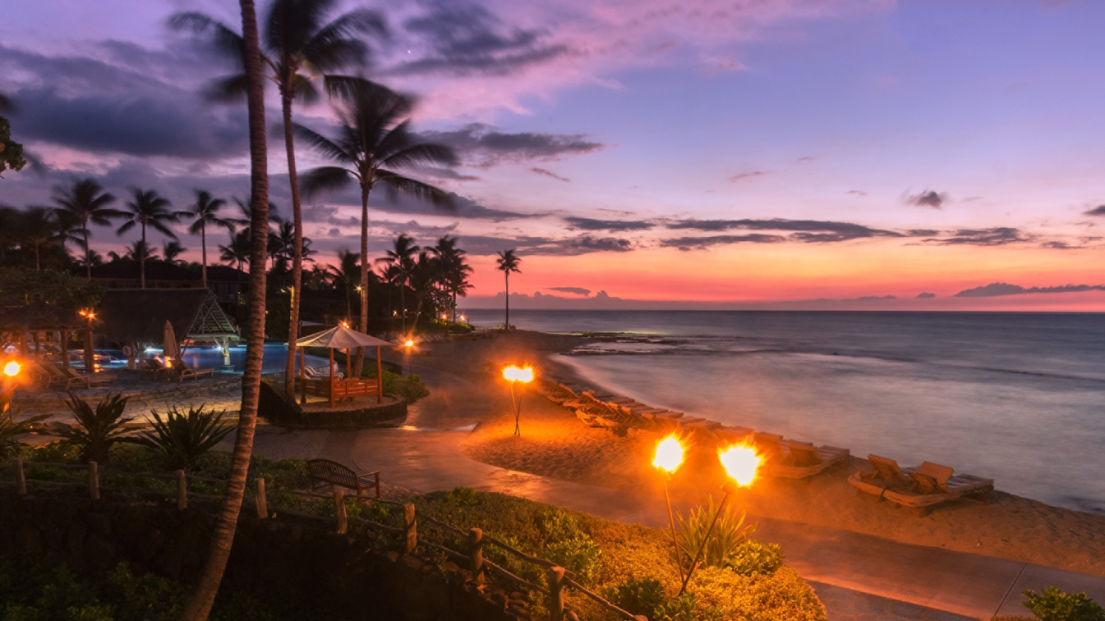 four-seasons-hualalai-sunset-beach-torches-big-island.jpg